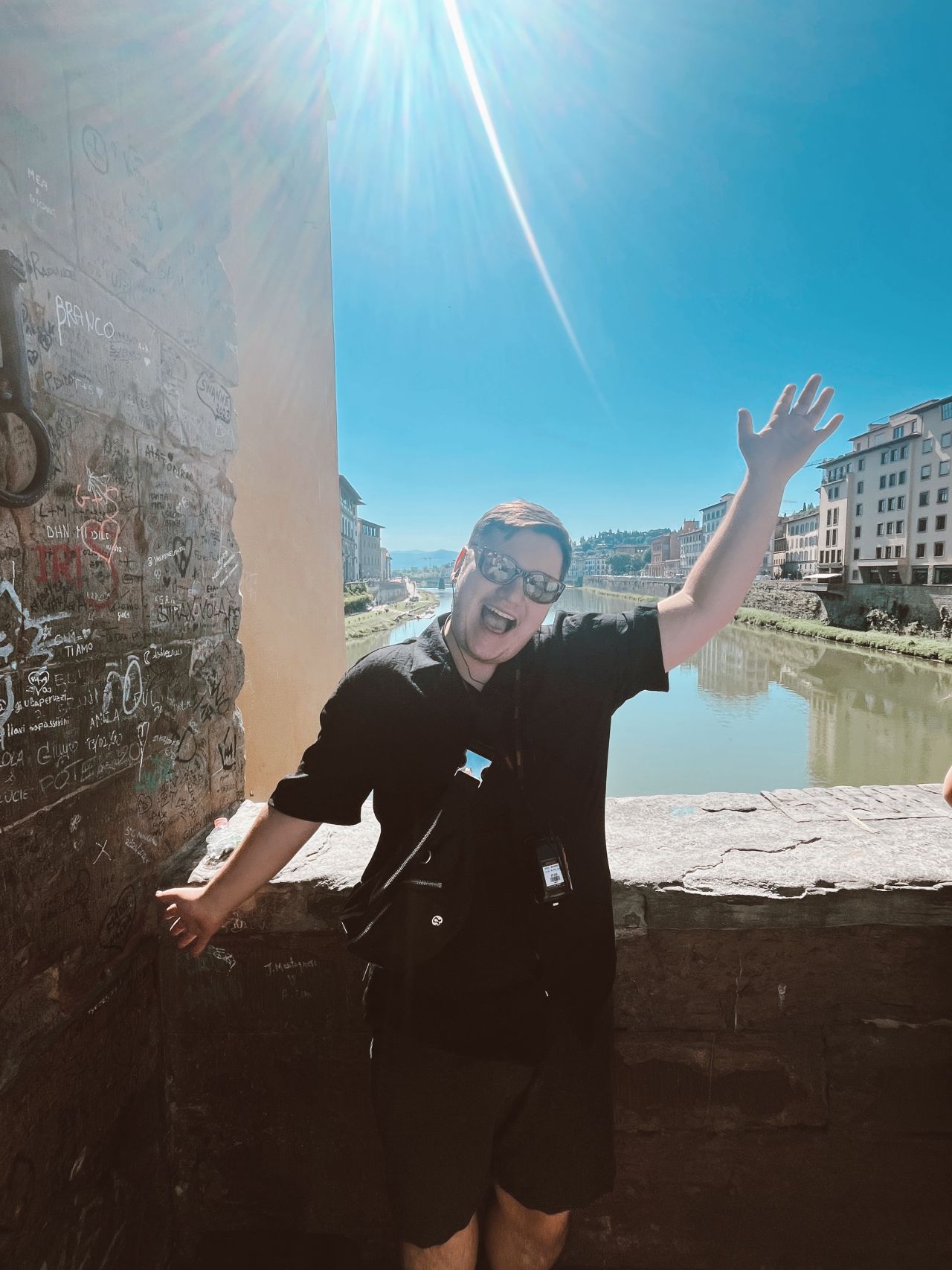 UNC Pembroke student Dalton in Italy with arm up and smiling