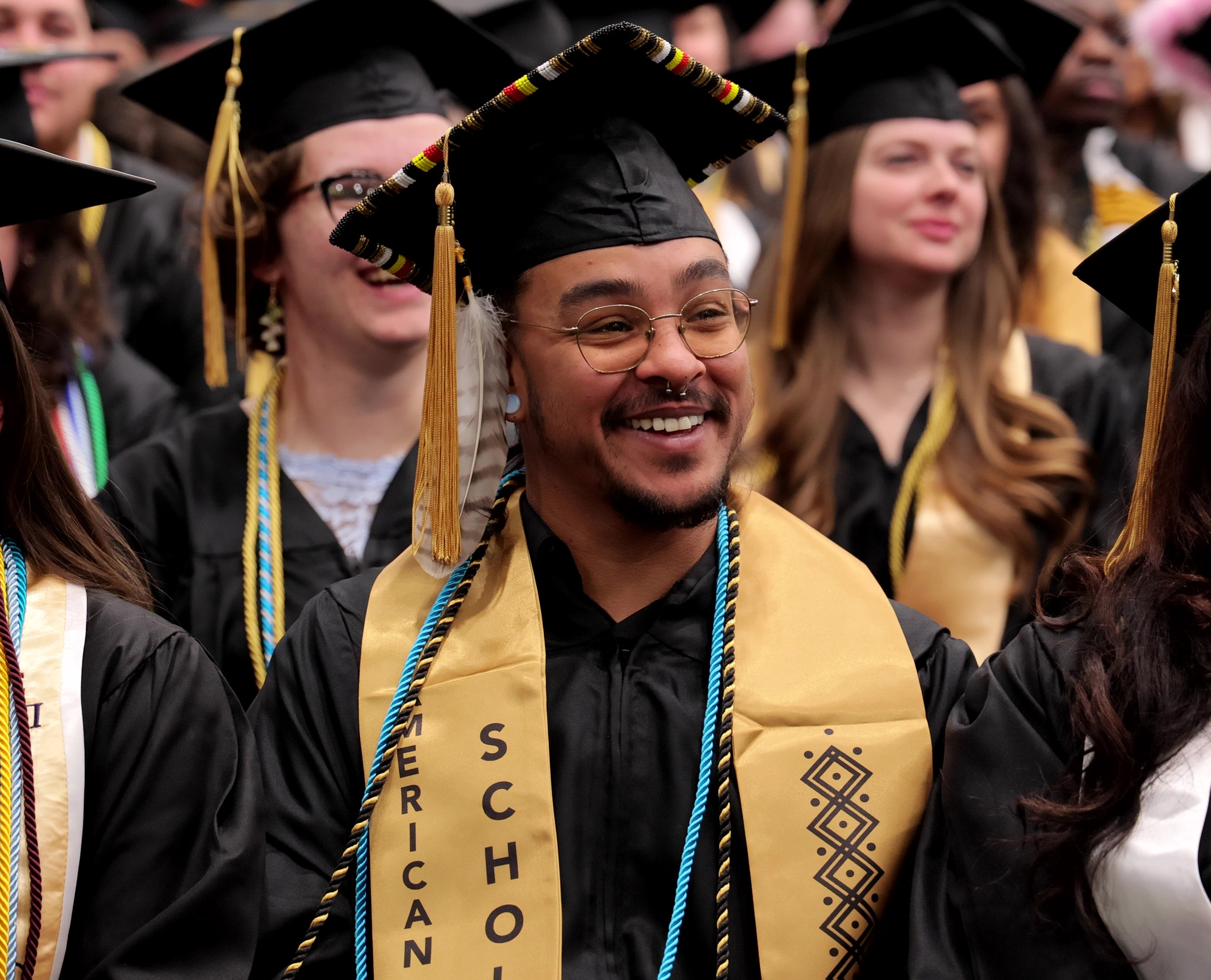 An AIS student smiles during commencement