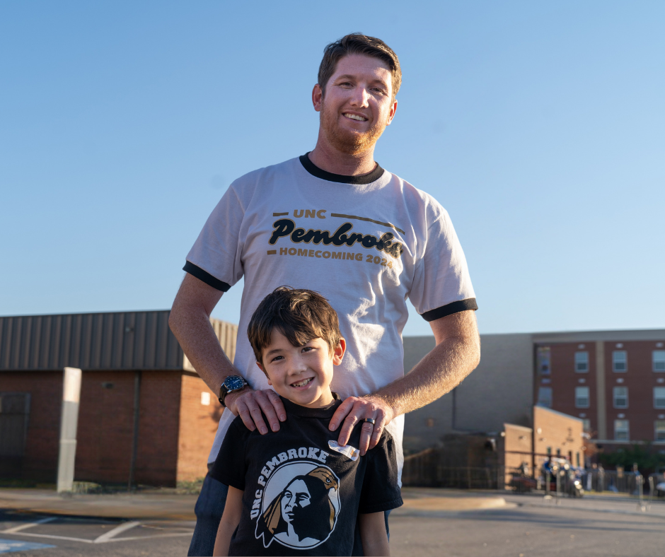 Branan Denard stands with his son on the UNCP Campus