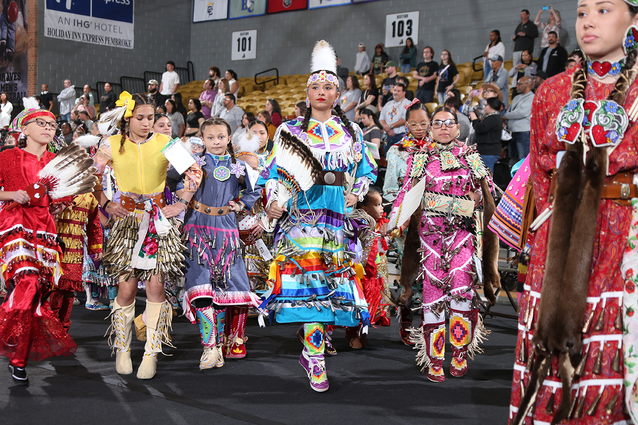 women in traditional American Indian dress at a PowWow