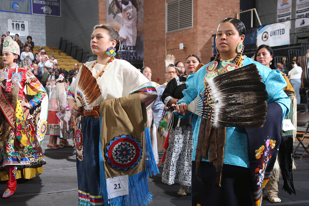women standing at attention in their native dress