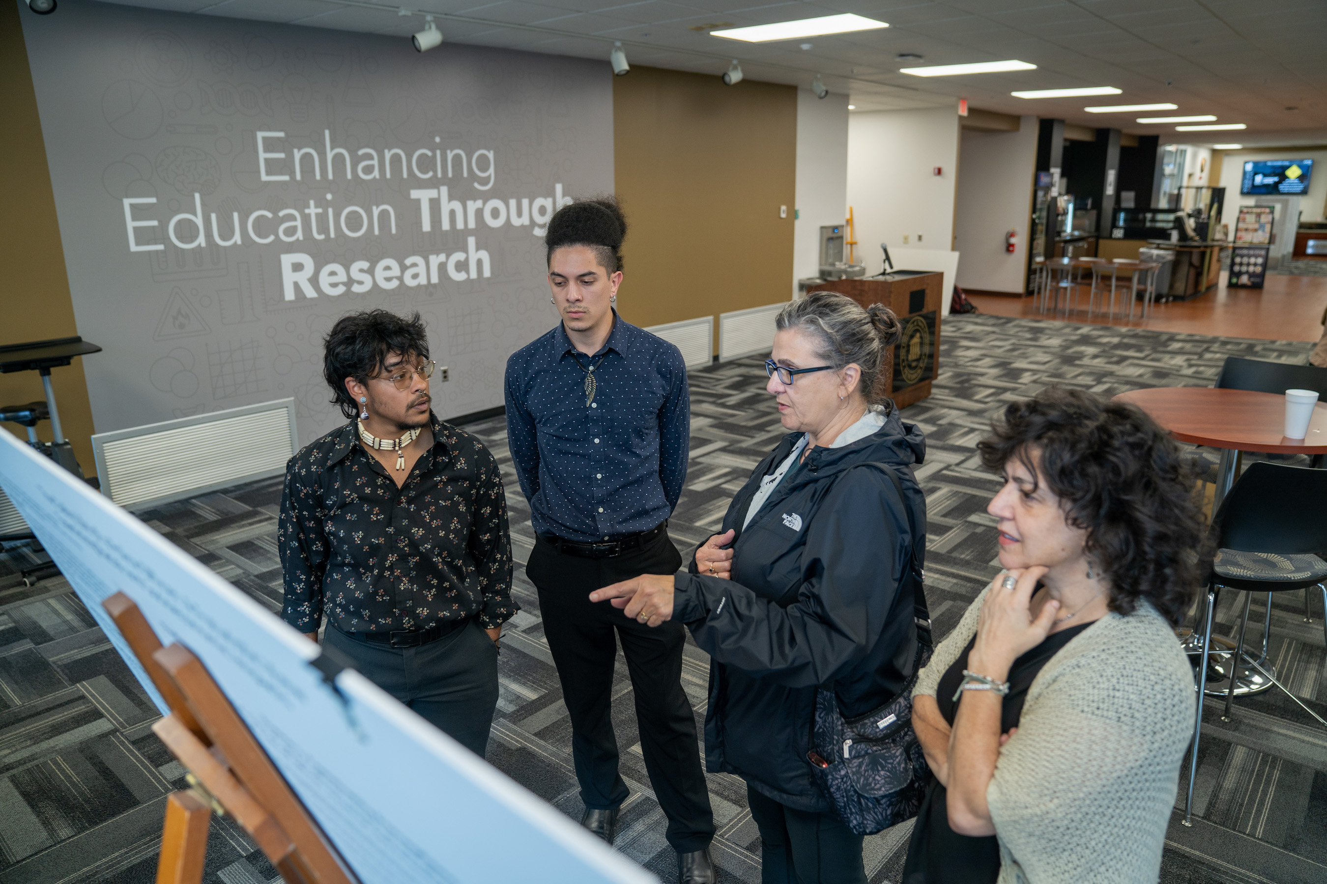REACH Fellow Ahe Oxouzidis (second from left) discusses his ongoing 'Reclaiming Lumbee Identity' project during a presentation