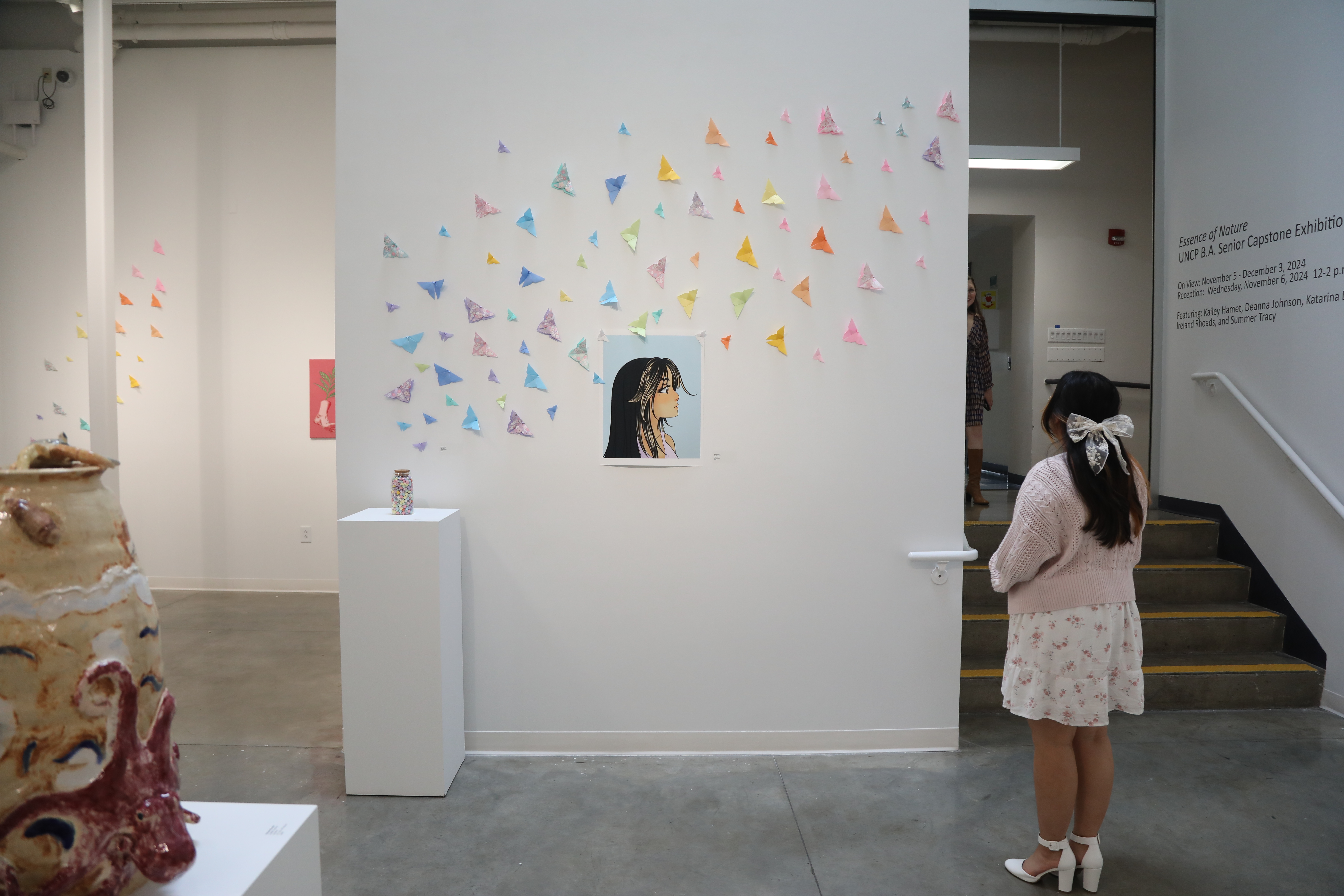 girl standing in front of an art display
