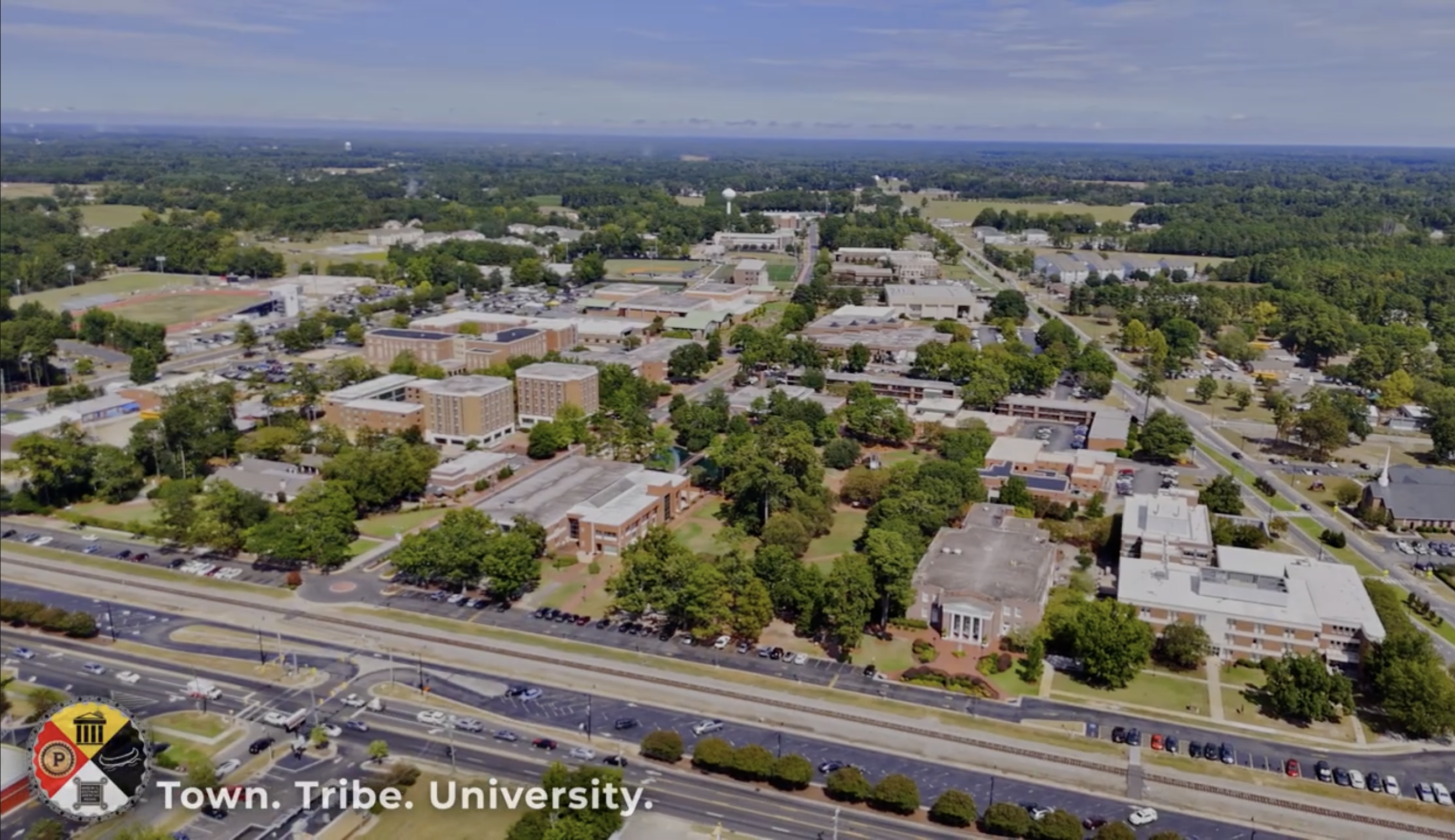 View from above of the UNCP campus with the words Town. Tribe. University in th corner of the image.