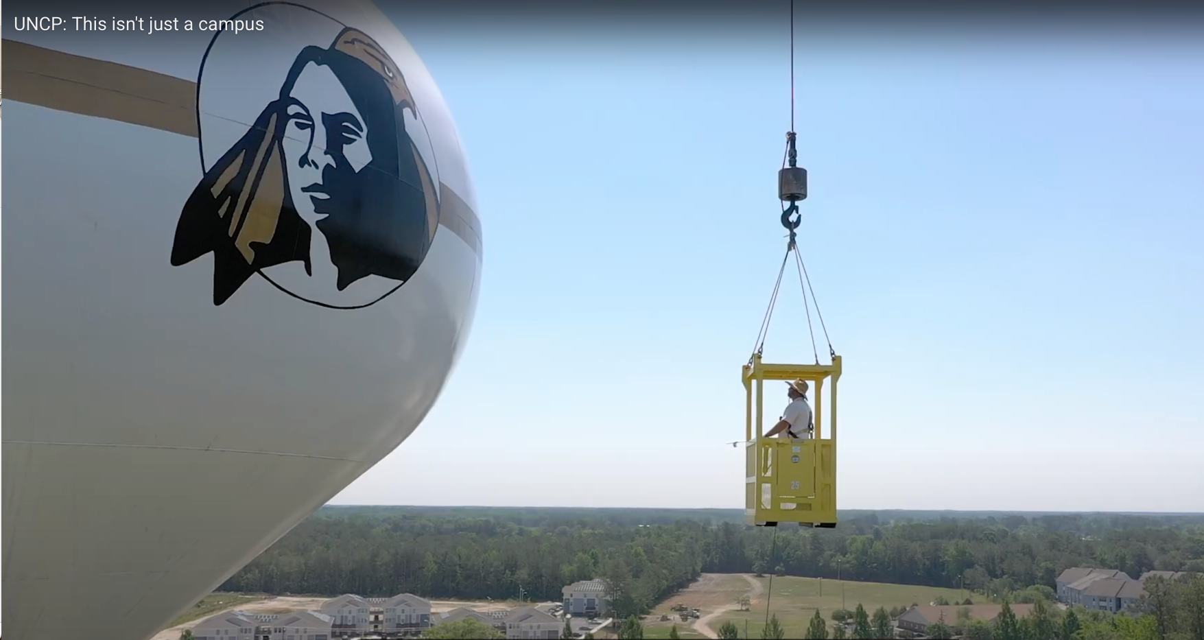 UNCP water tower and worker in lift