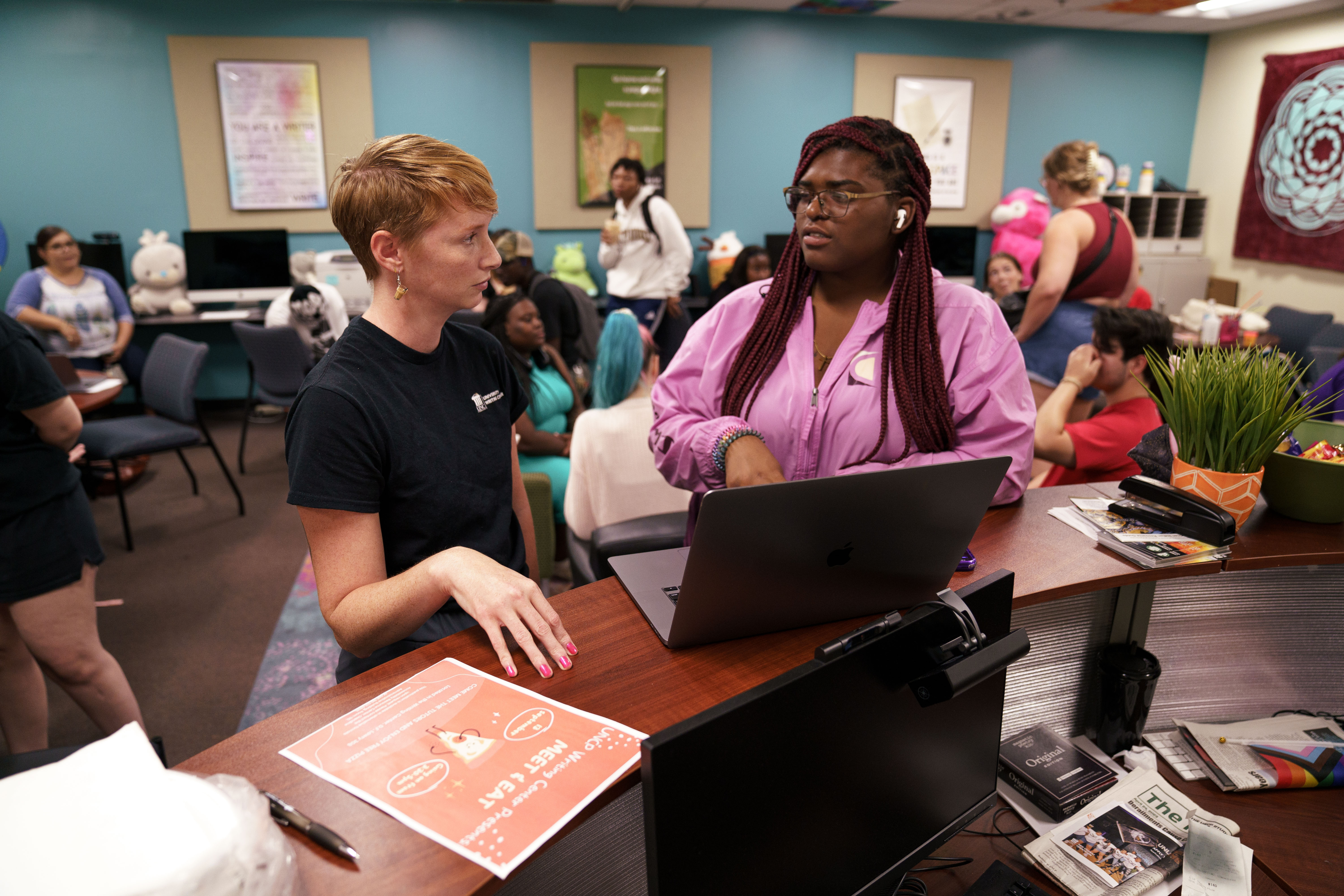 two women standing and talking in the UNCP Writing Center