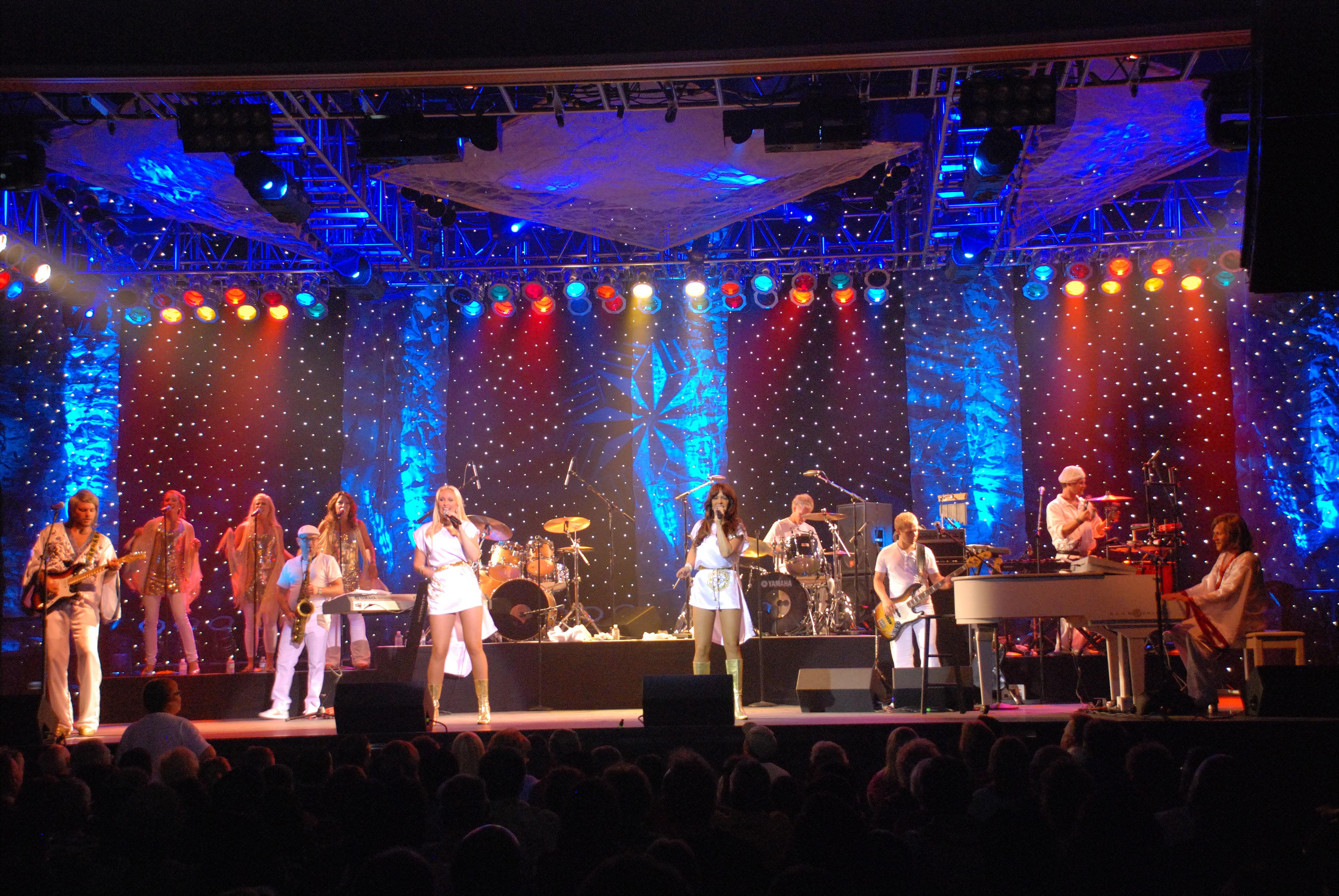 Band members perform on stage