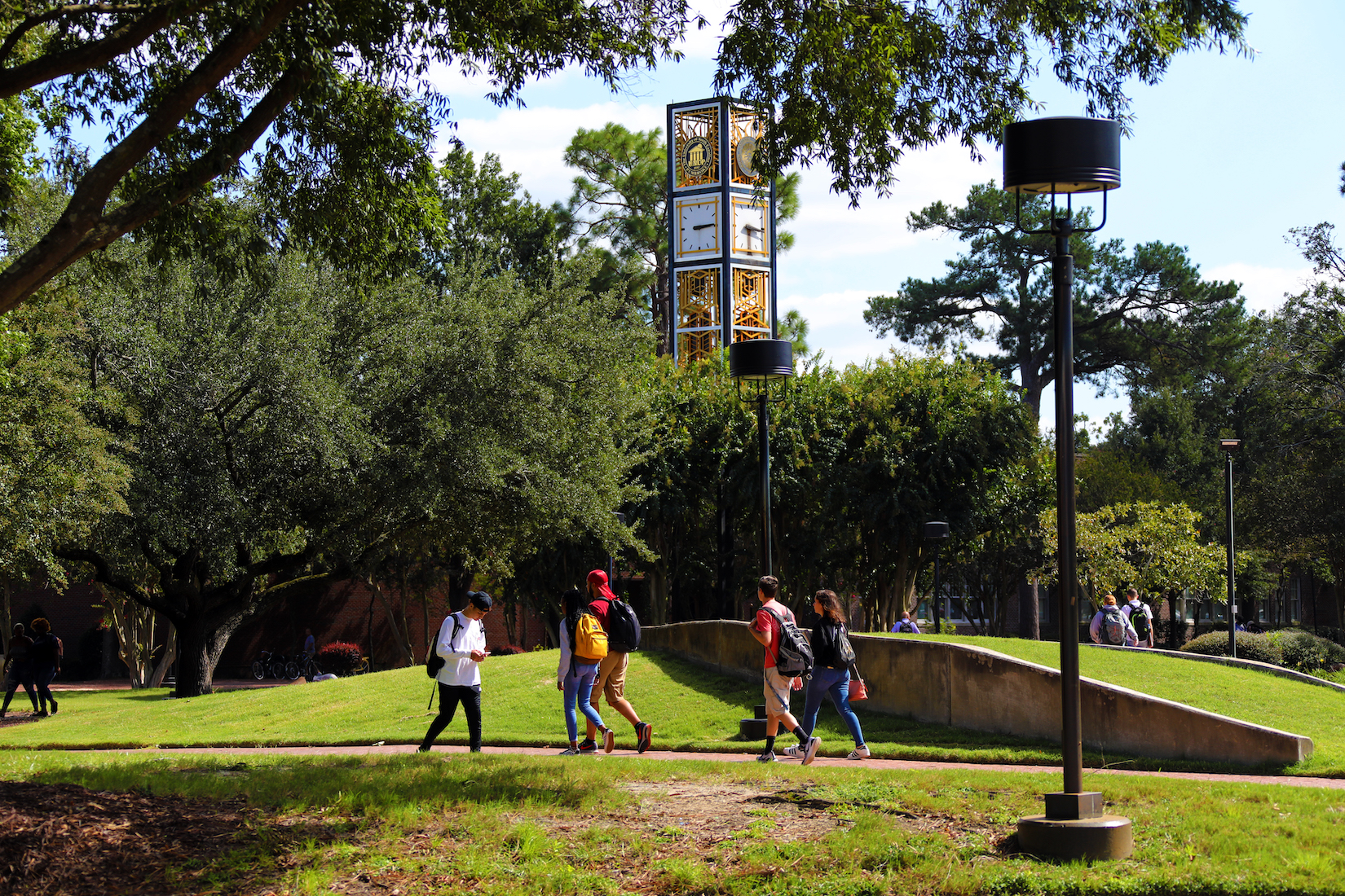 The campus of UNC Pembroke with a clocktower in the background.
