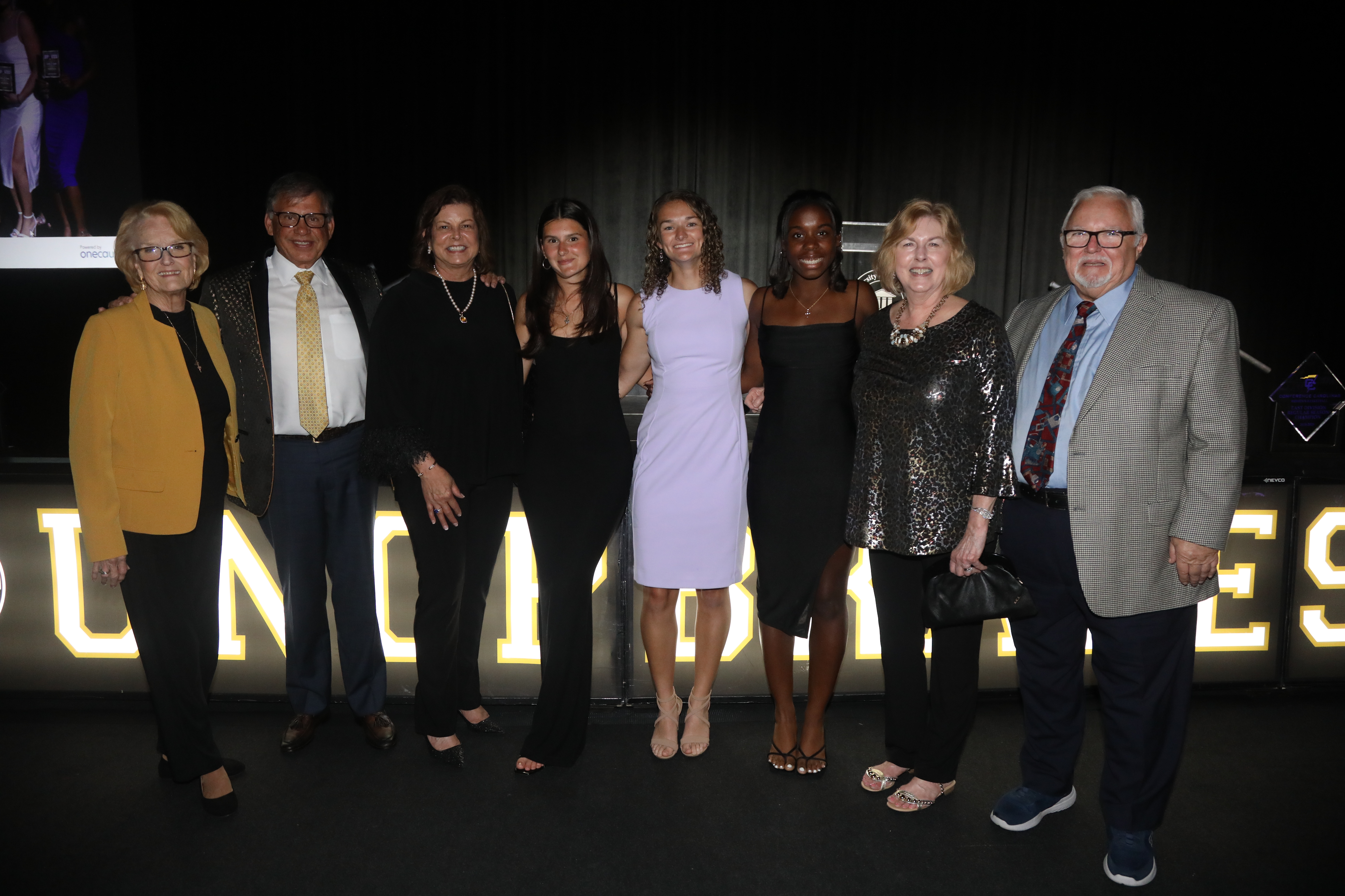 UNCP students pose with Chancellor Cummings and other UNCP leaders at Cash Bash 2025.