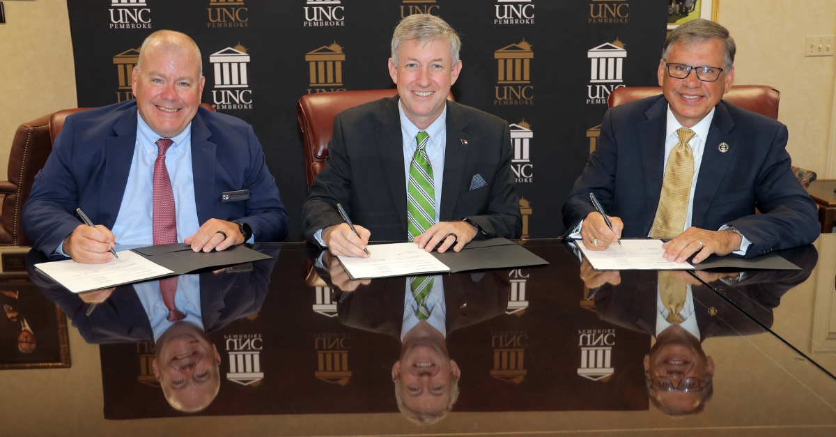 Moore County Schools Superintendent Tim Locklair, left, Sandhills Community College President Sandy Stewart and UNCP Chancellor Robin Gary Cummings