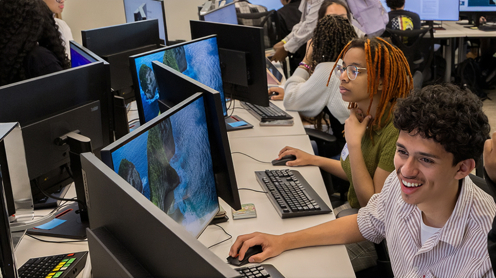 UNCP students work at computers in a campus lab, representing the hands-on technology learning experiences supported by the $4.935 million Title III grant to advance AI and student success.