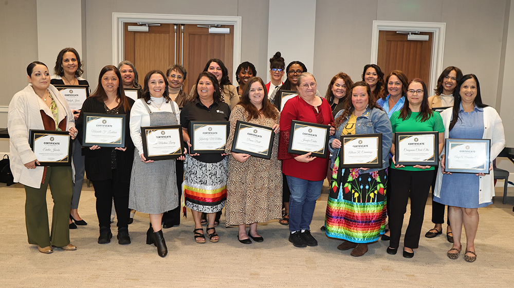 staff members pose with their Exceptional Executive Assistant certificates