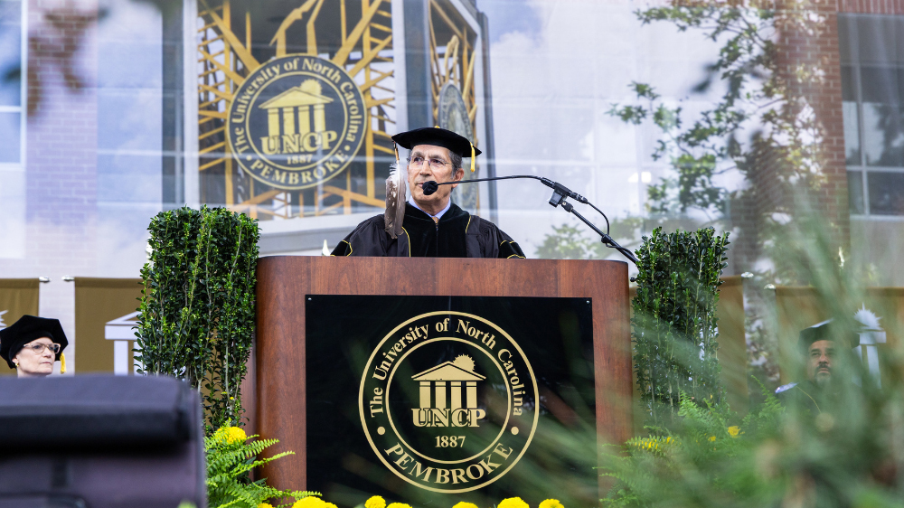 Dr. John Herrington delivers the commencement address during UNC Pembroke’s William Howard Dean Graduate School commencement ceremony
