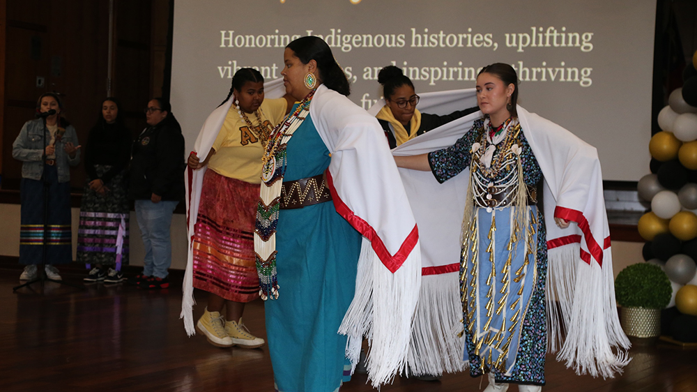 Members of Alpha Pi Omega perform a traditional swan dance during an Indigenous Peoples' Day event