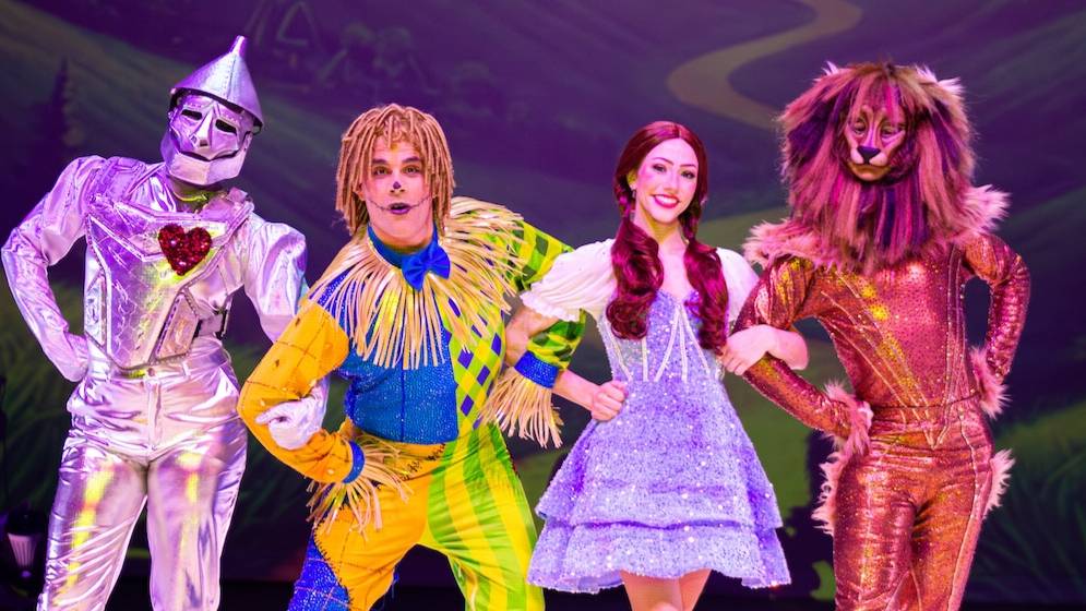 Performers in elaborate costumes portraying the Tin Man, Scarecrow, Dorothy and the Cowardly Lion on stage in The Wizard of Oz on Ice, coming to the GPAC at UNC Pembroke on April 30.