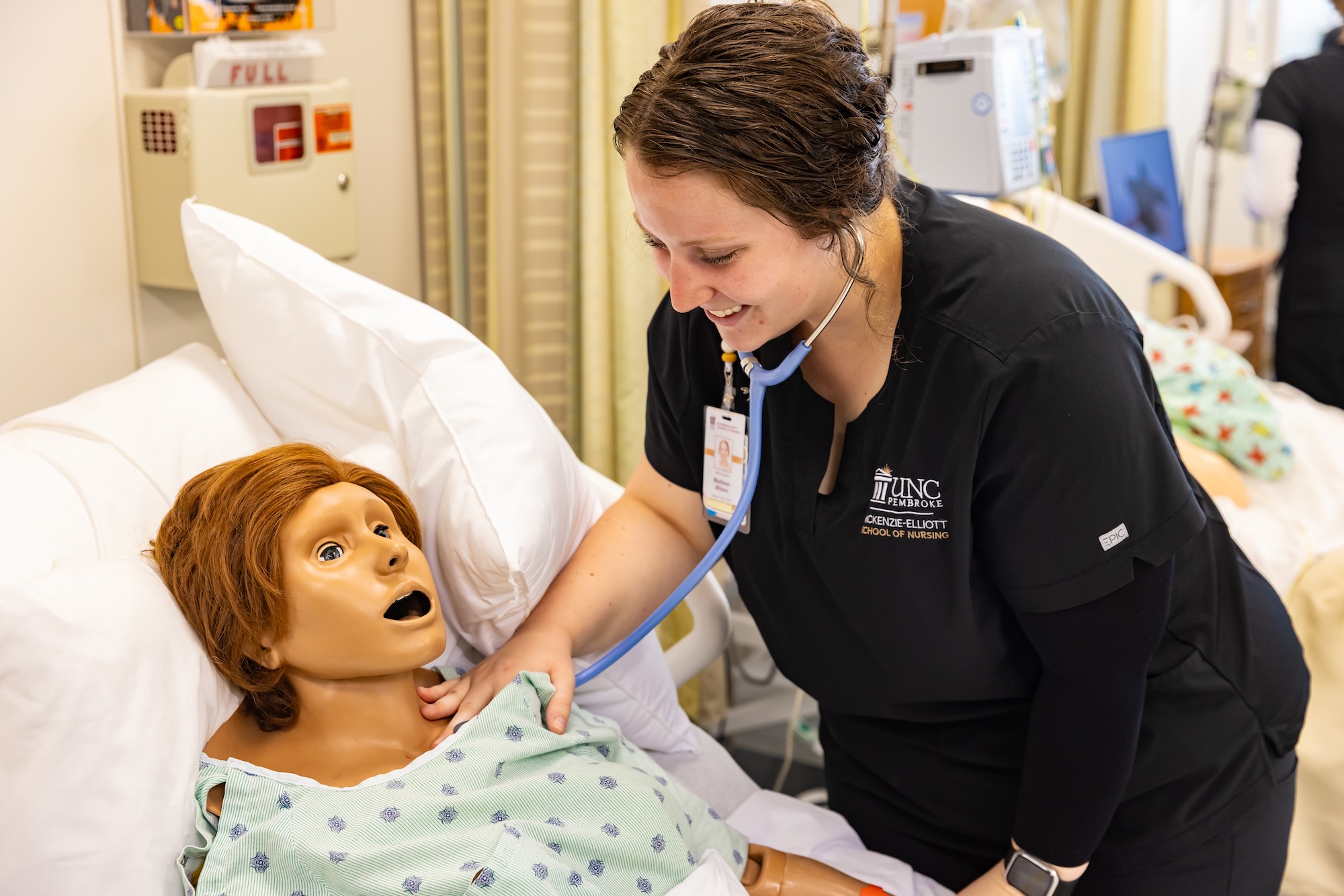 UNCP student with a dummy in the Clinical Learning Center