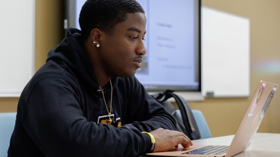 student sitting at laptop