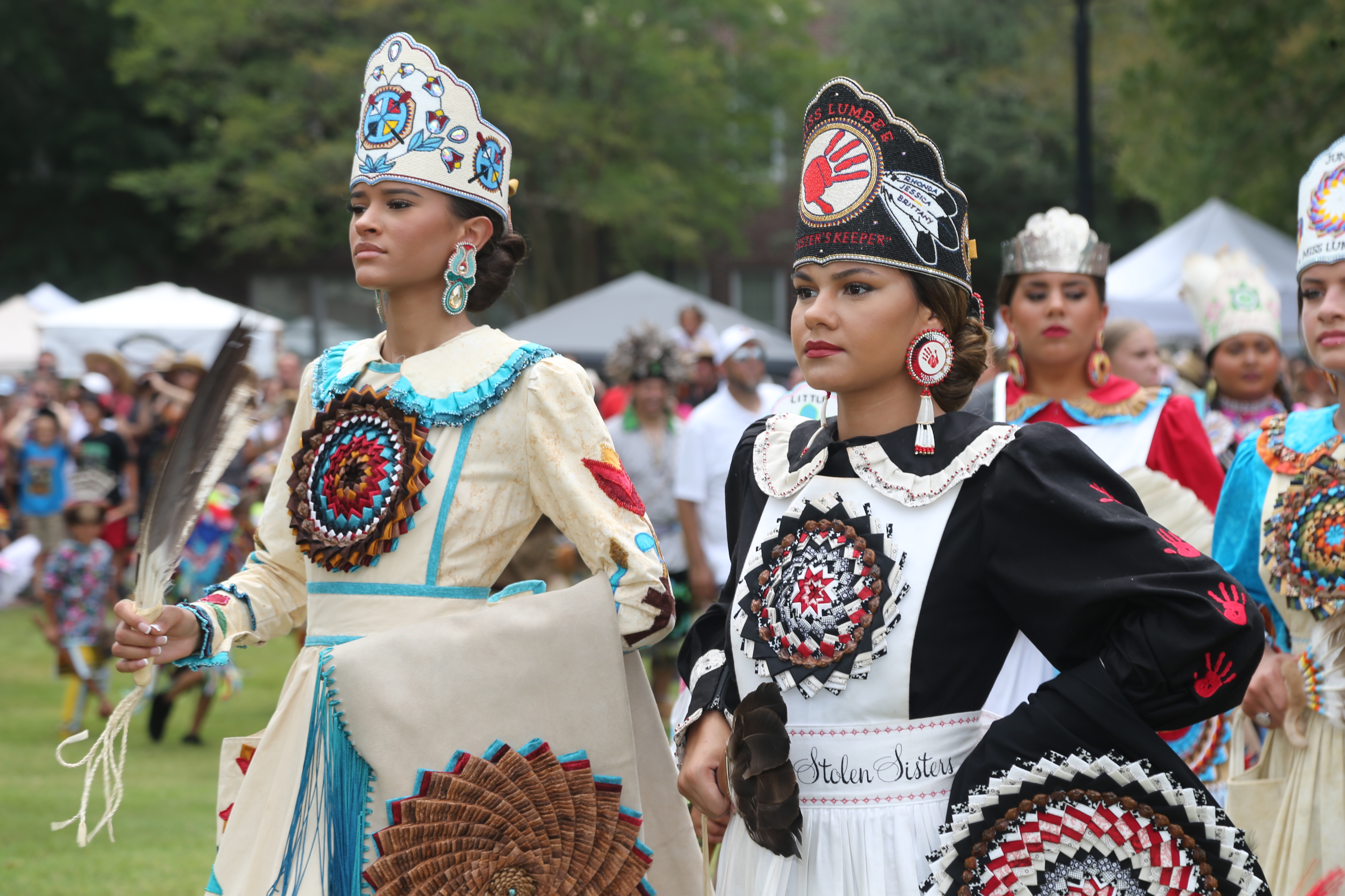 Women dressed in traditional American Indian regalia
