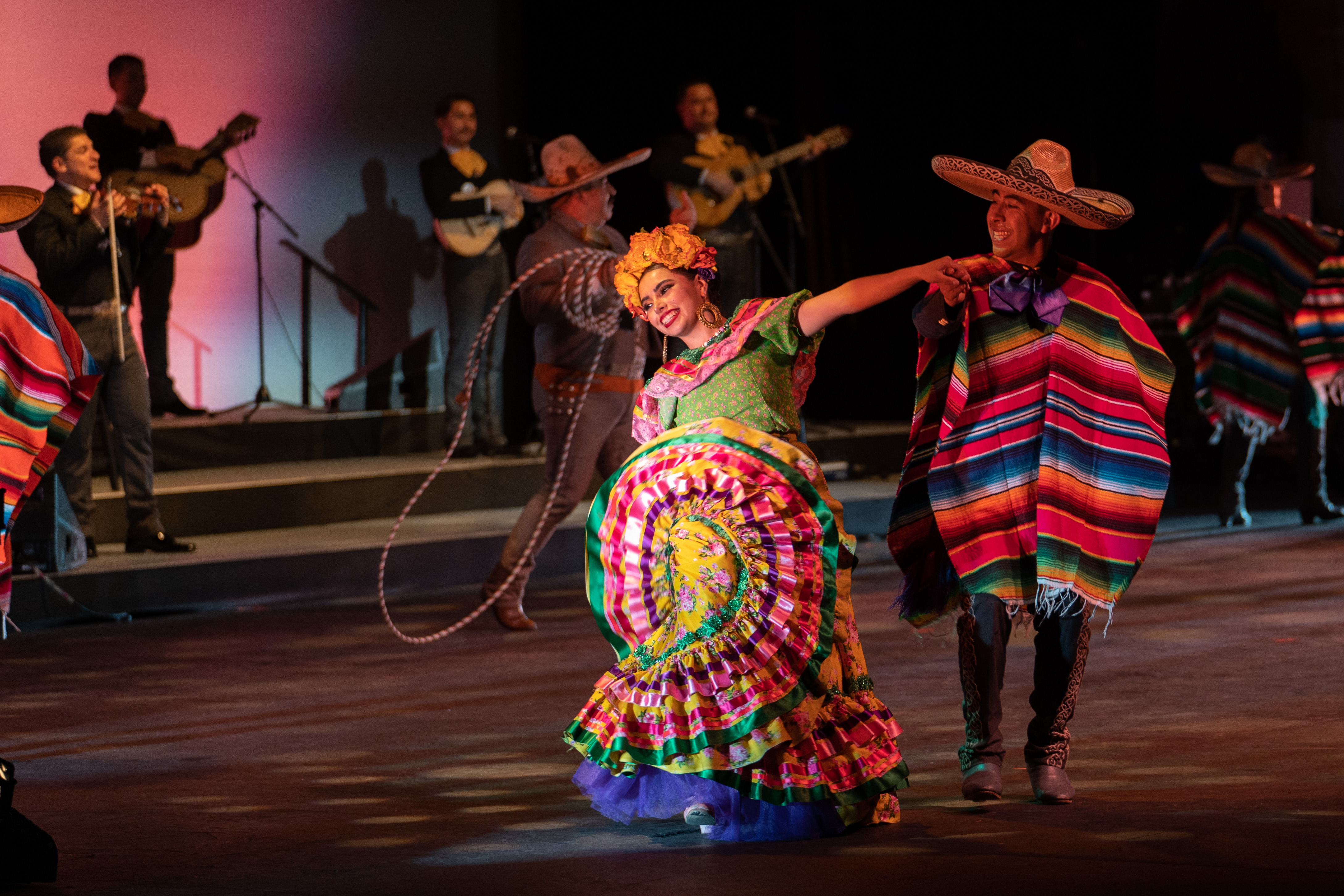 woman in brightly colored clothing dancing in the musical Offend