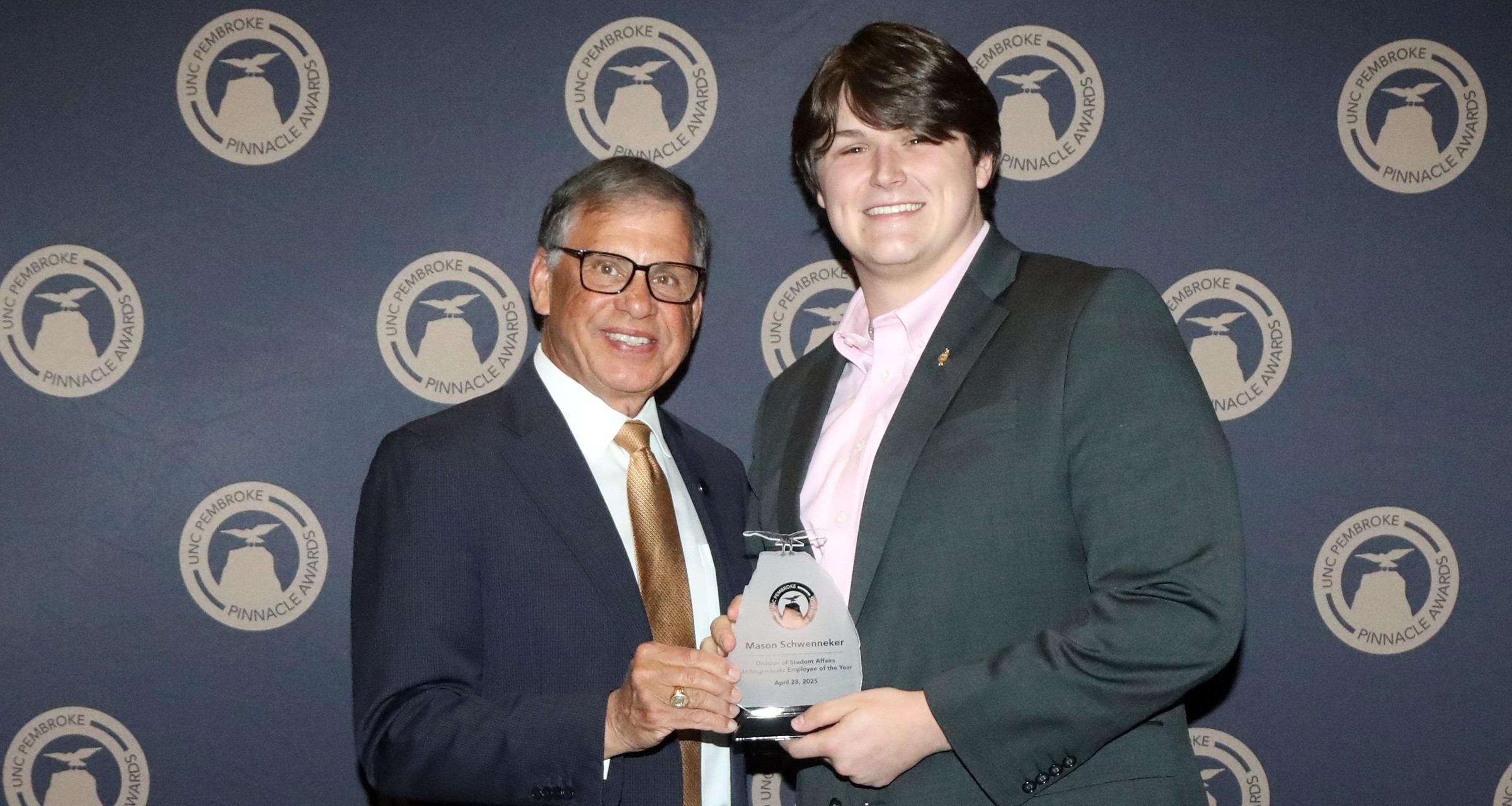 Honors student accepting an award from UNC Pembroke Chancellor Robin Cummings
