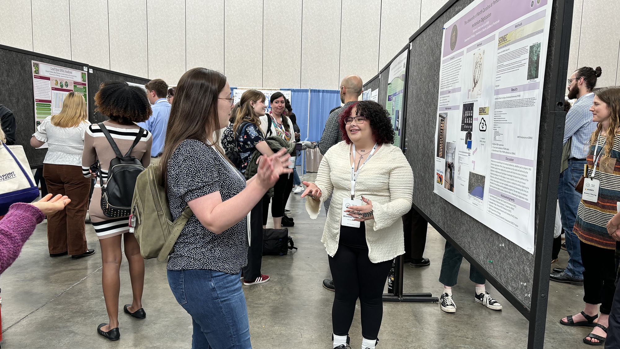 Shannon Lowry explains her reserach project to a passerby.