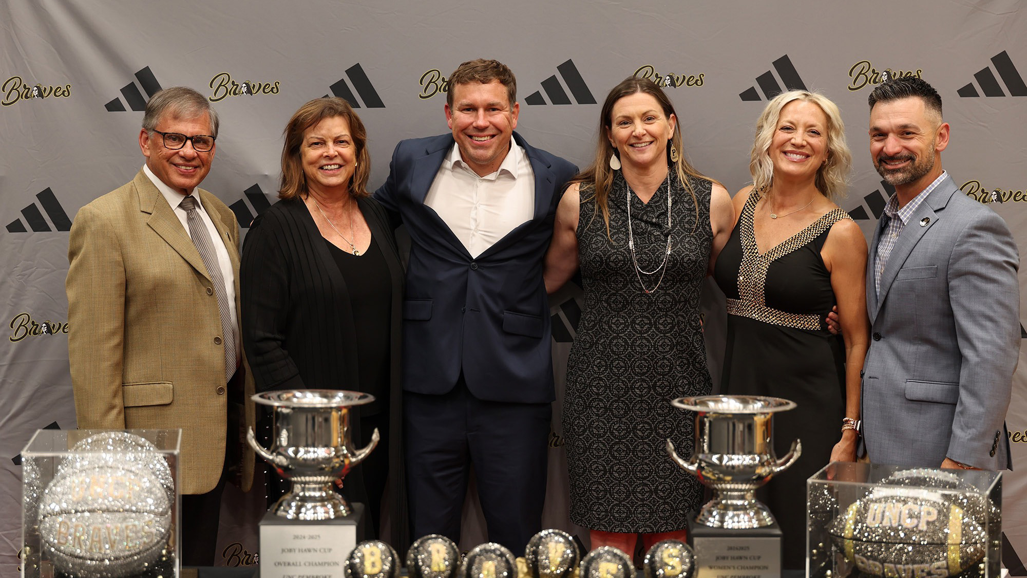 Chancellor Robin Cummings and First Lady Rebecca Cummings pose with UNCP Athletics leadership.