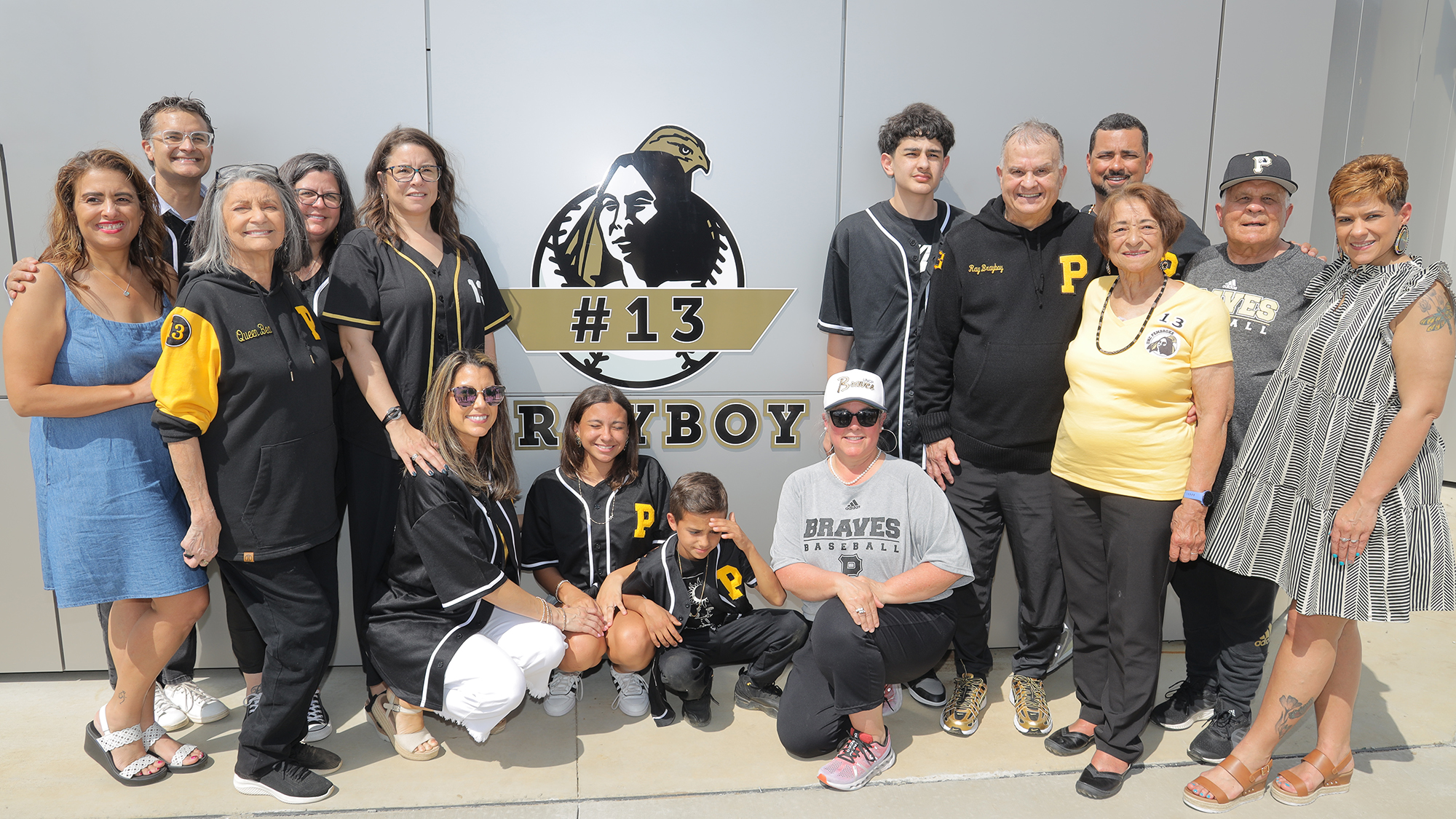 family photo of the Brayboys surrounding the retirement image on the wall