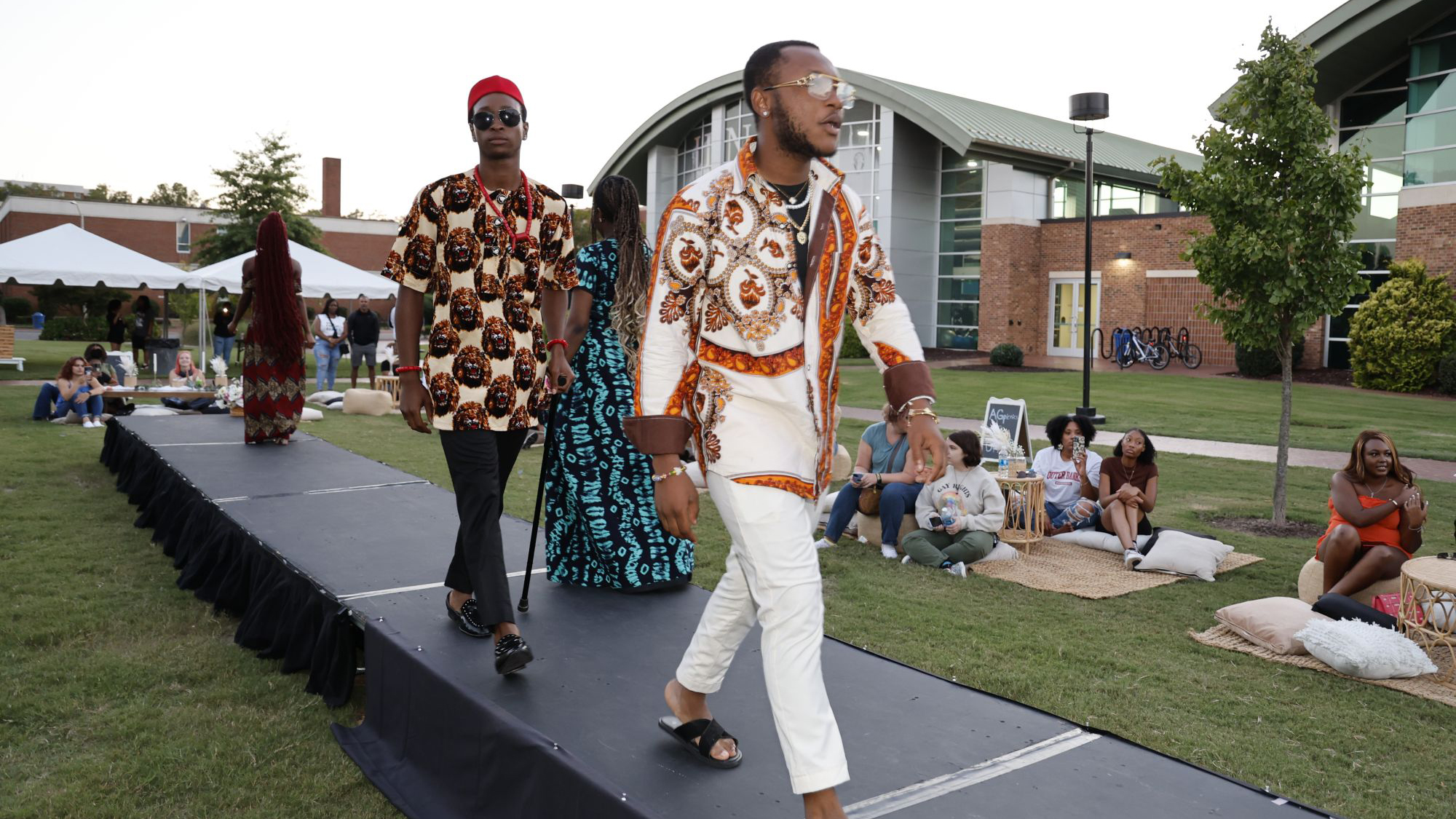 UNCP international students showcase African fashions on stage at the OGE cultural fashion show.