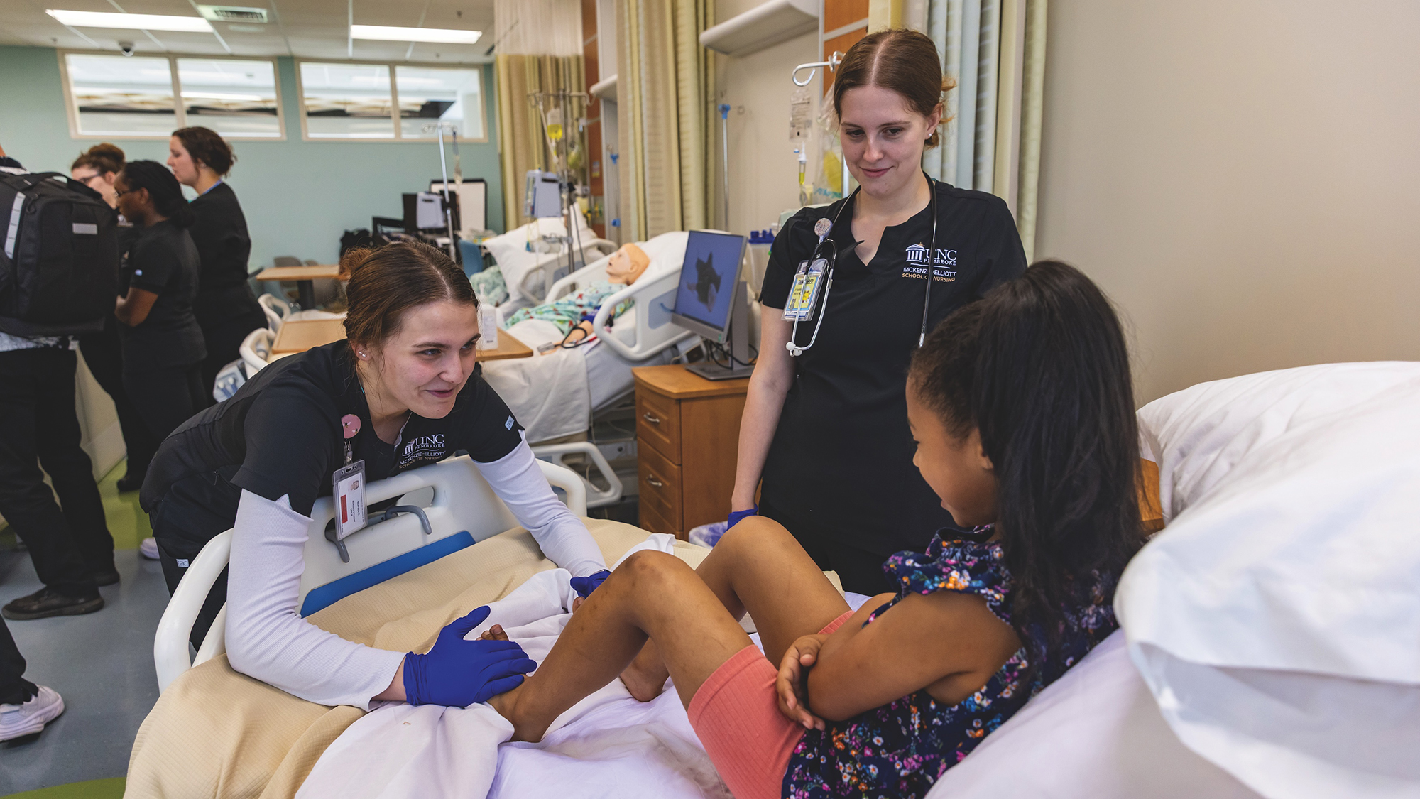 student female nurses perform diagnosis on young female patient