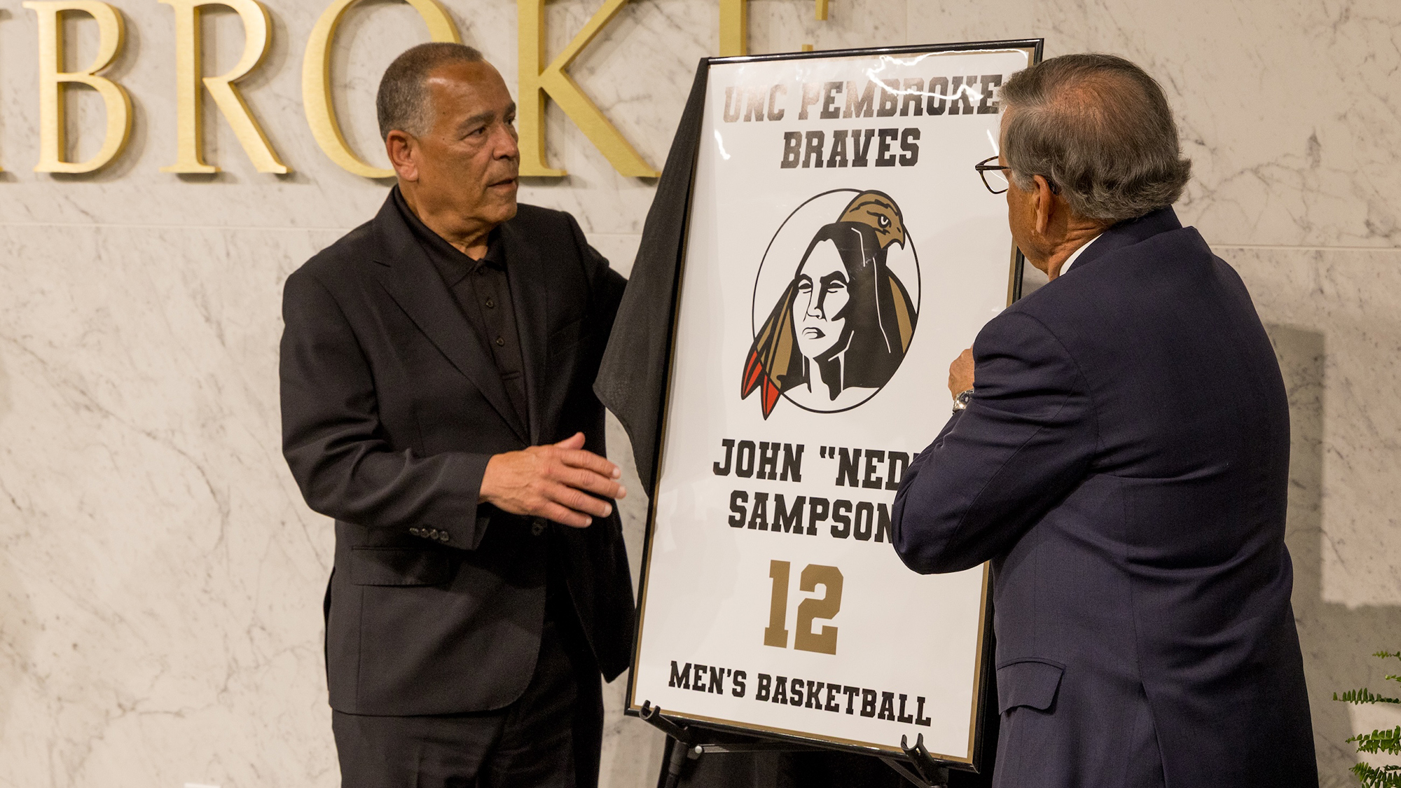 Kelvin Sampson and Chancellor Robin Gary Cummings unveil Ned Sampson's retired No. 12 jersey at the ceremony.