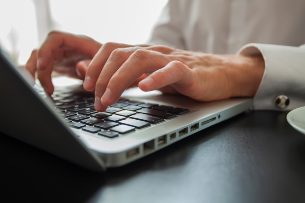 hands on a laptop