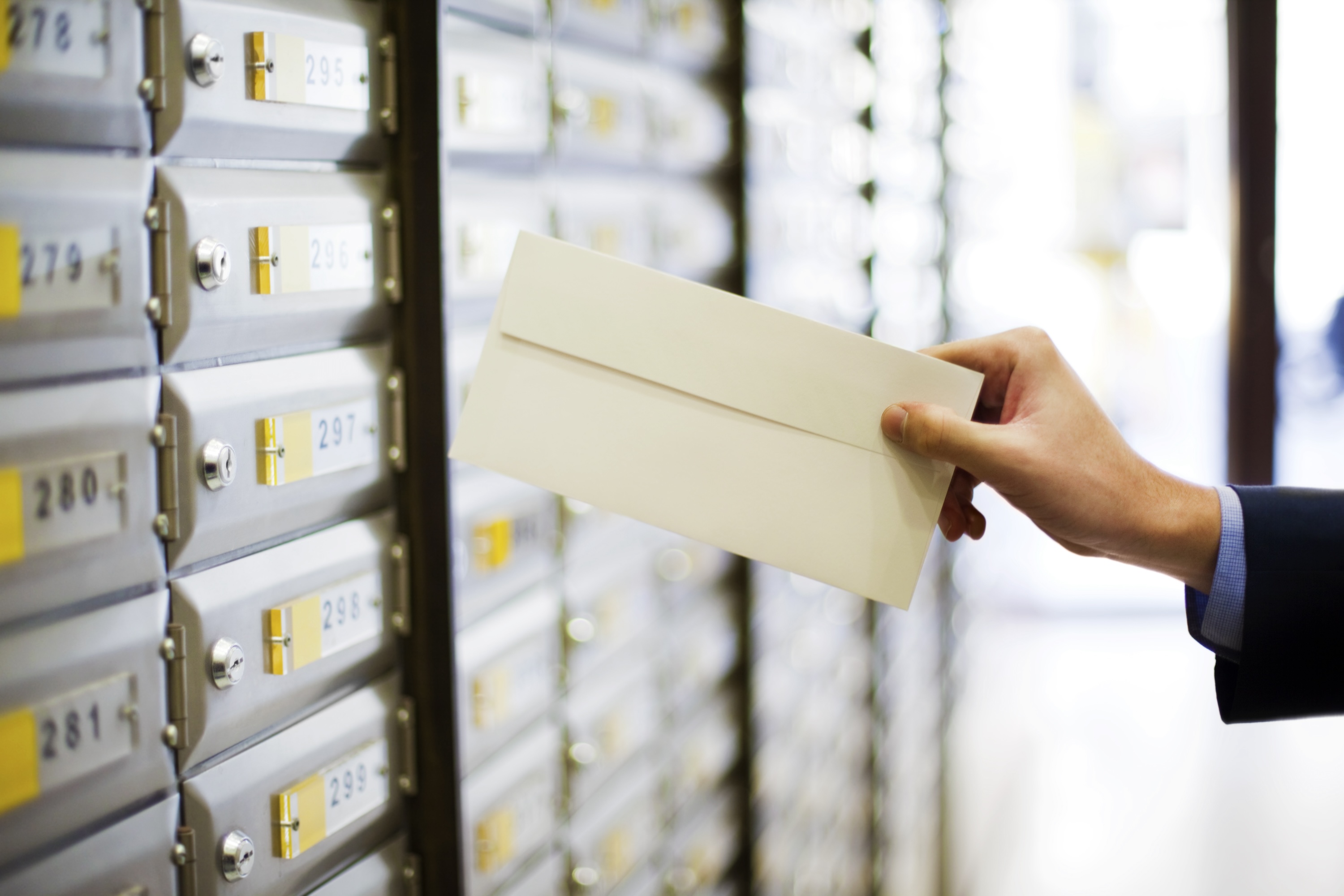 hand putting mail in slot