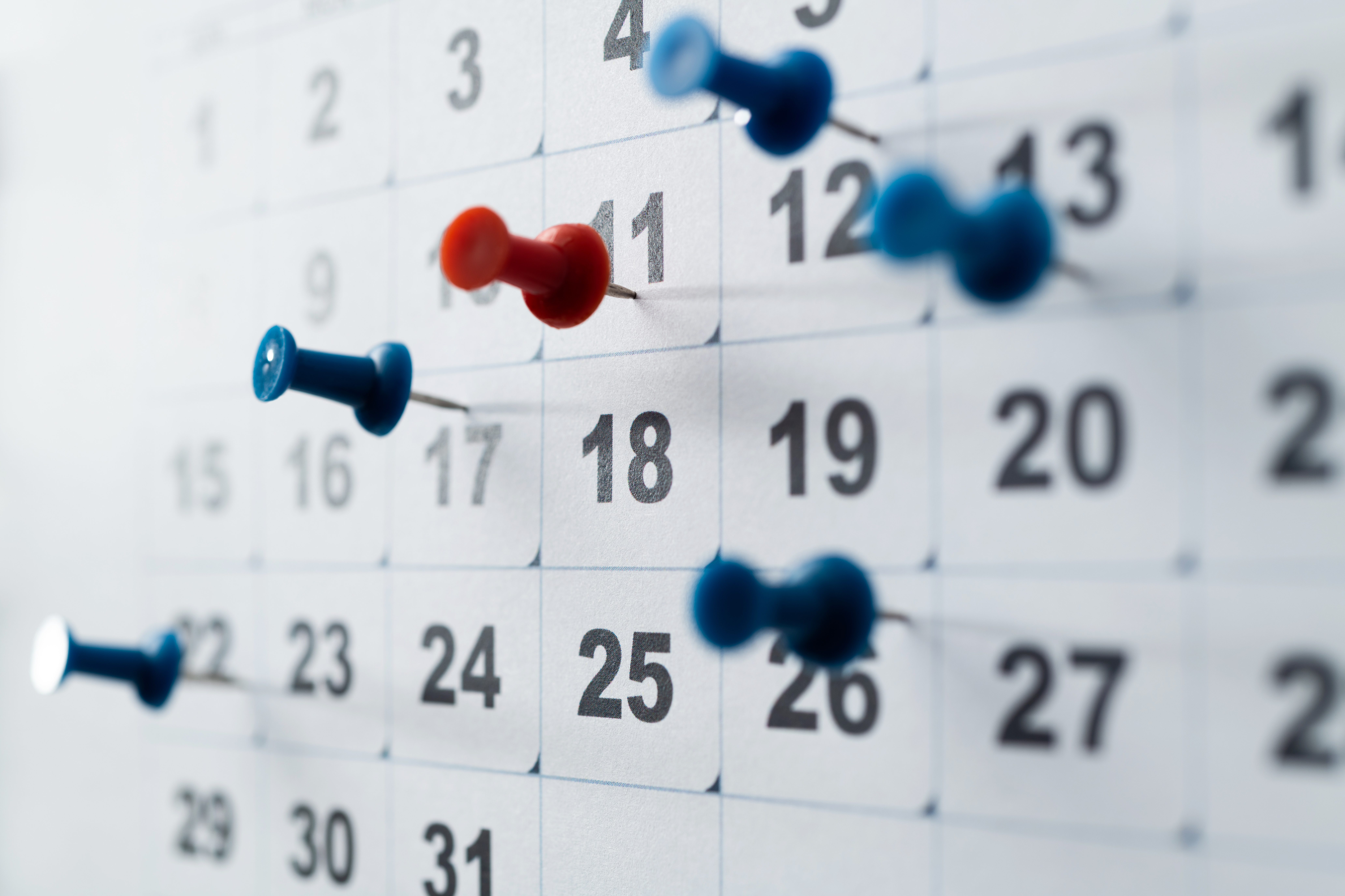 Calendar with push pins on important dates