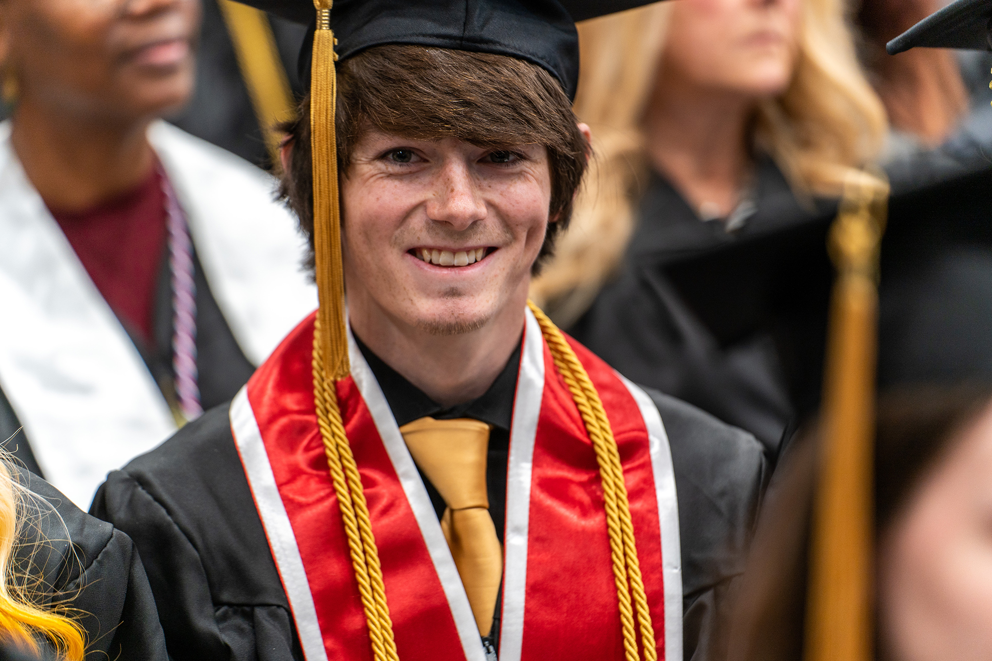 male UNCP graduate in cap and gown