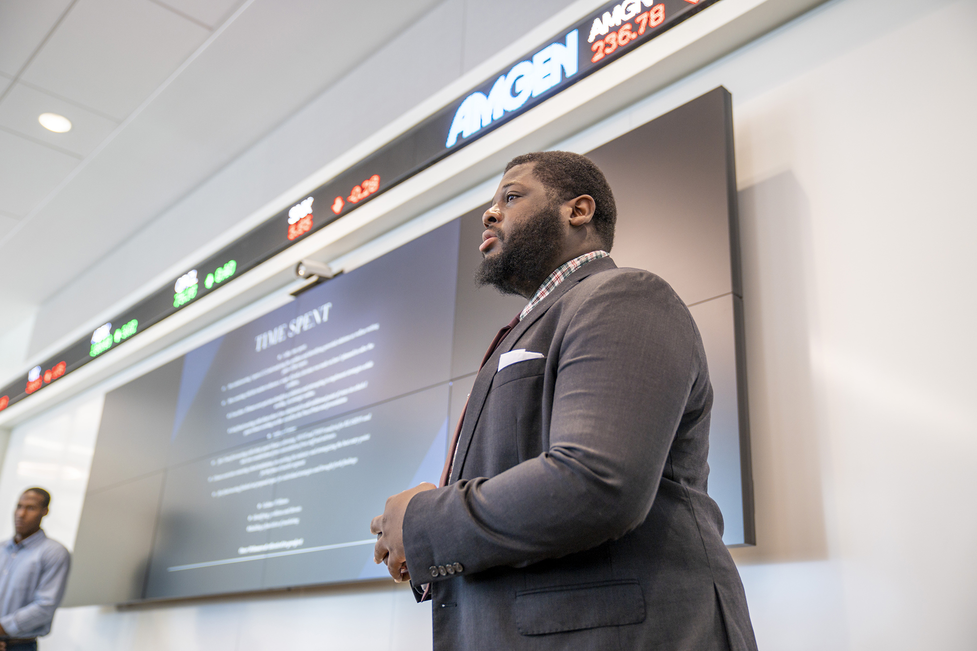 a man giving a presentation in front of a screen