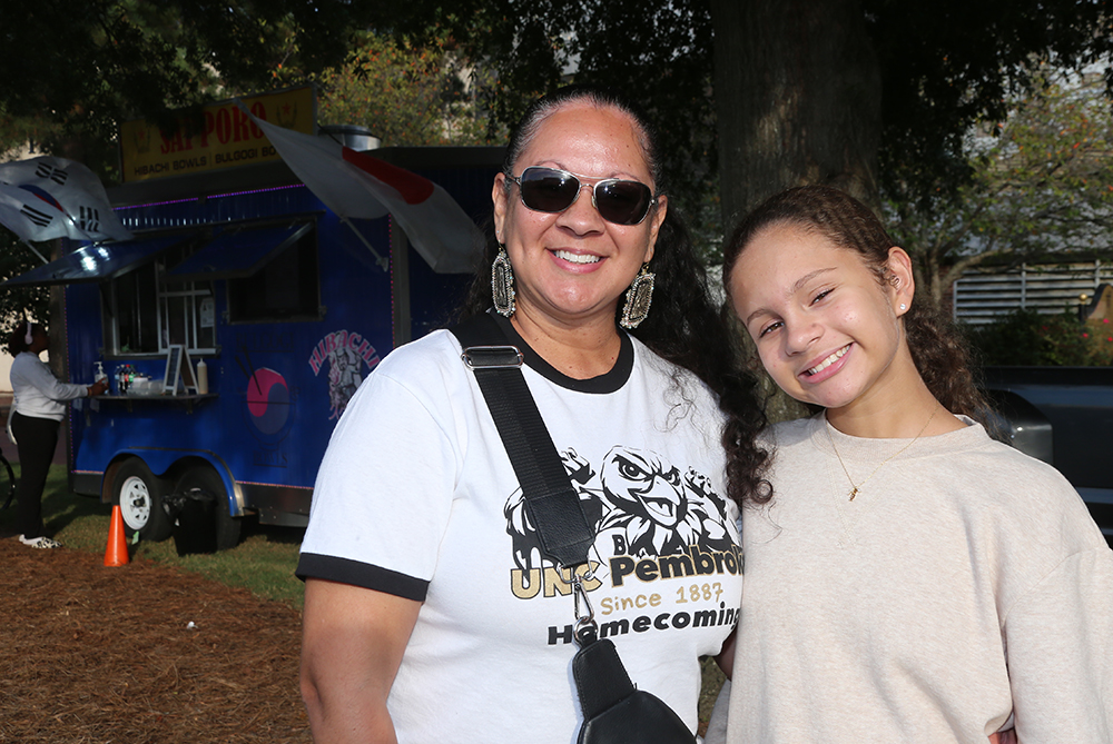 Alumni with her daughter in front of a food truck at UNCP's Beats 'n Eats event