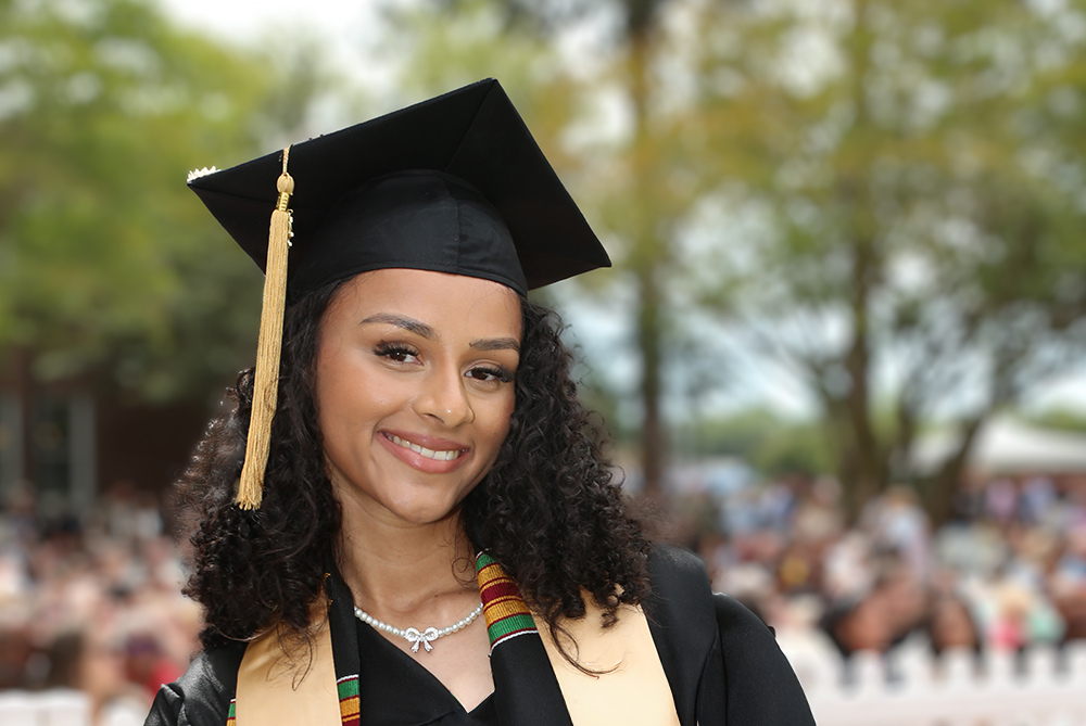 a graduate smiling after she recieved her degree