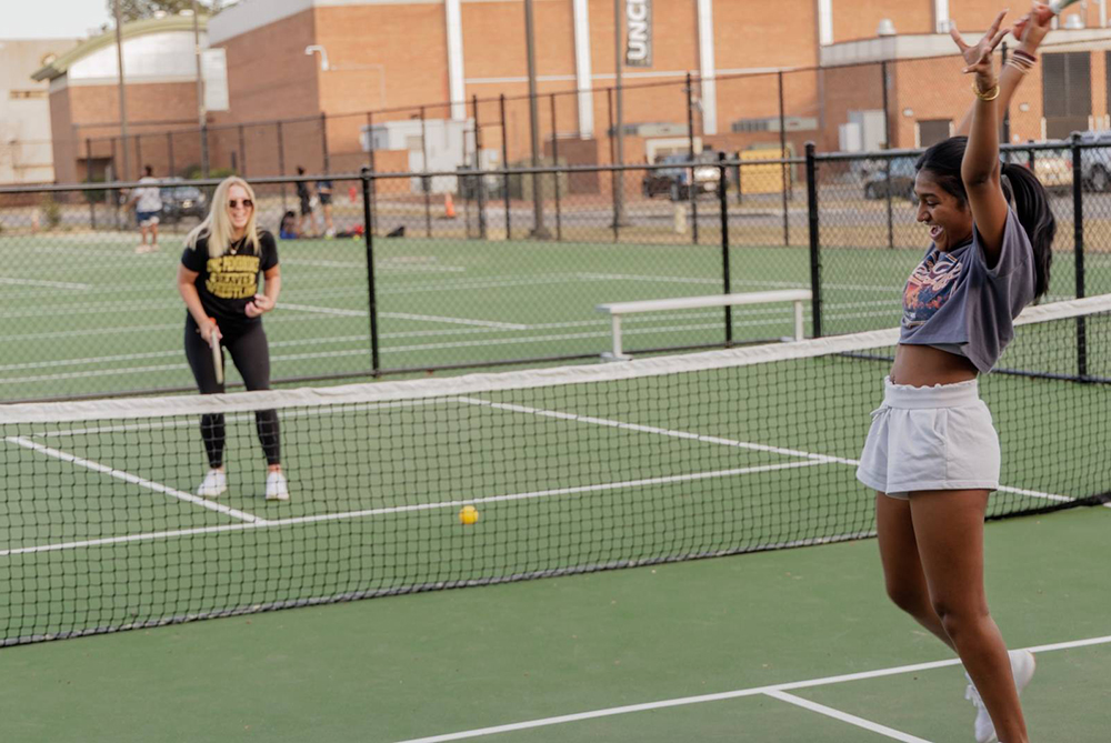 female uncp students playing pickleball