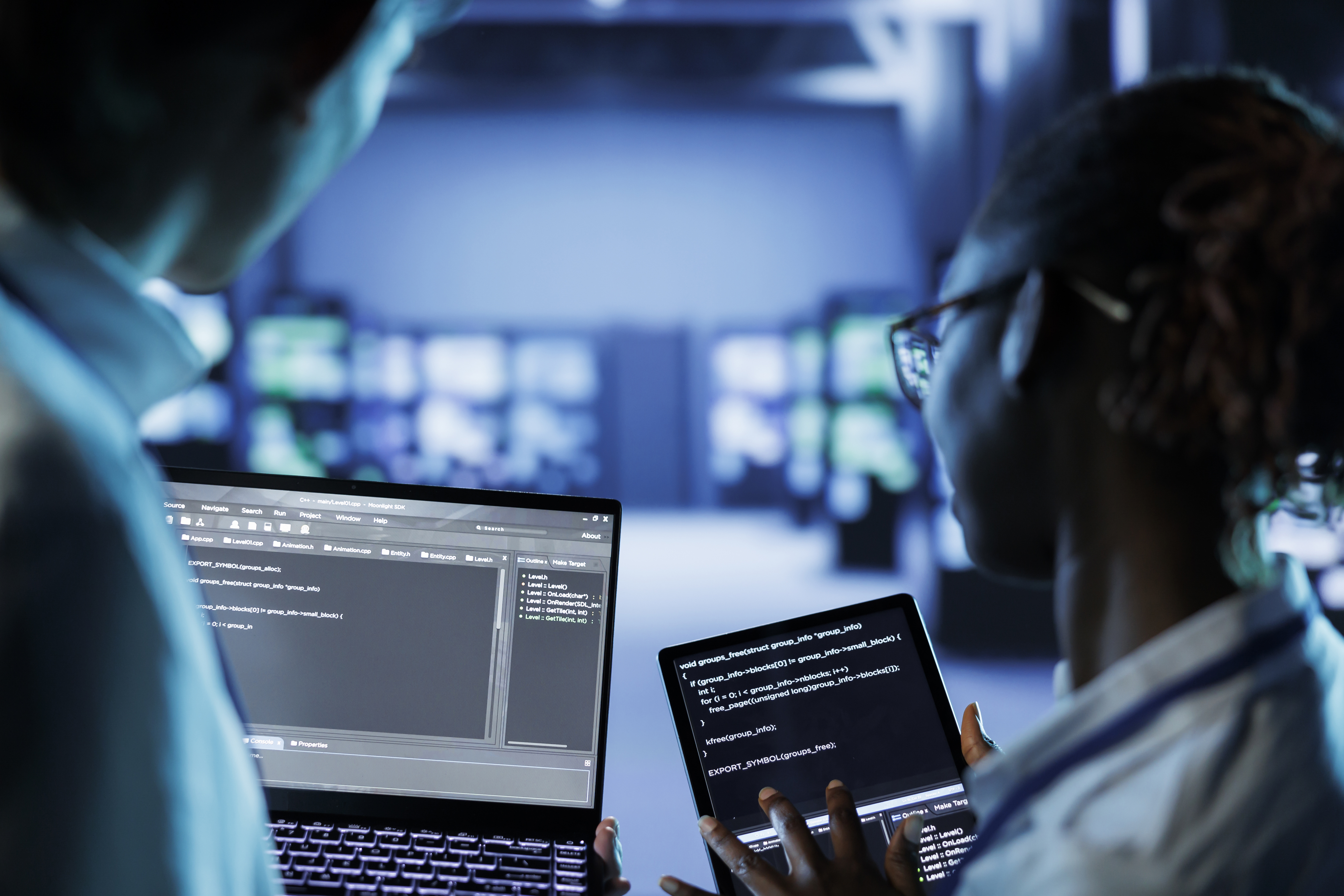 image of a young female with a computer in a blue lit room
