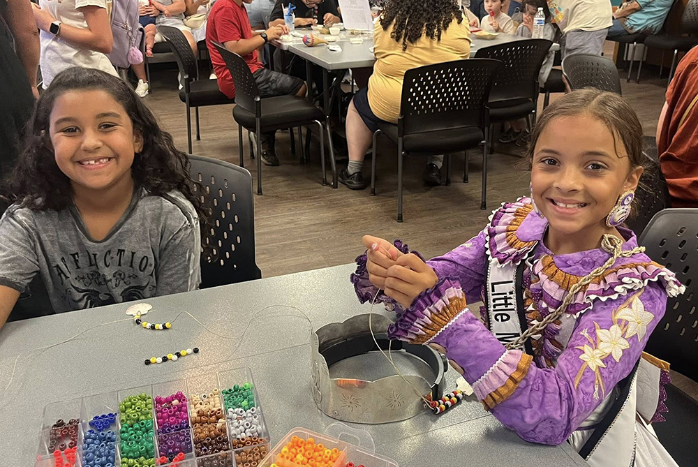 2 girls hold up crafts