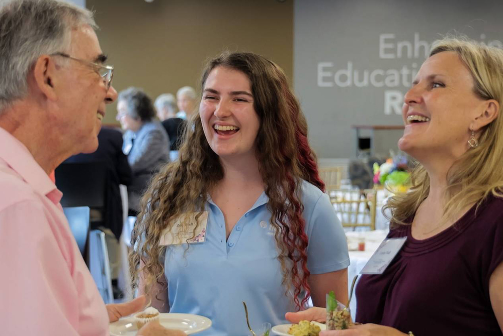 UNCP event where a student is talking to people