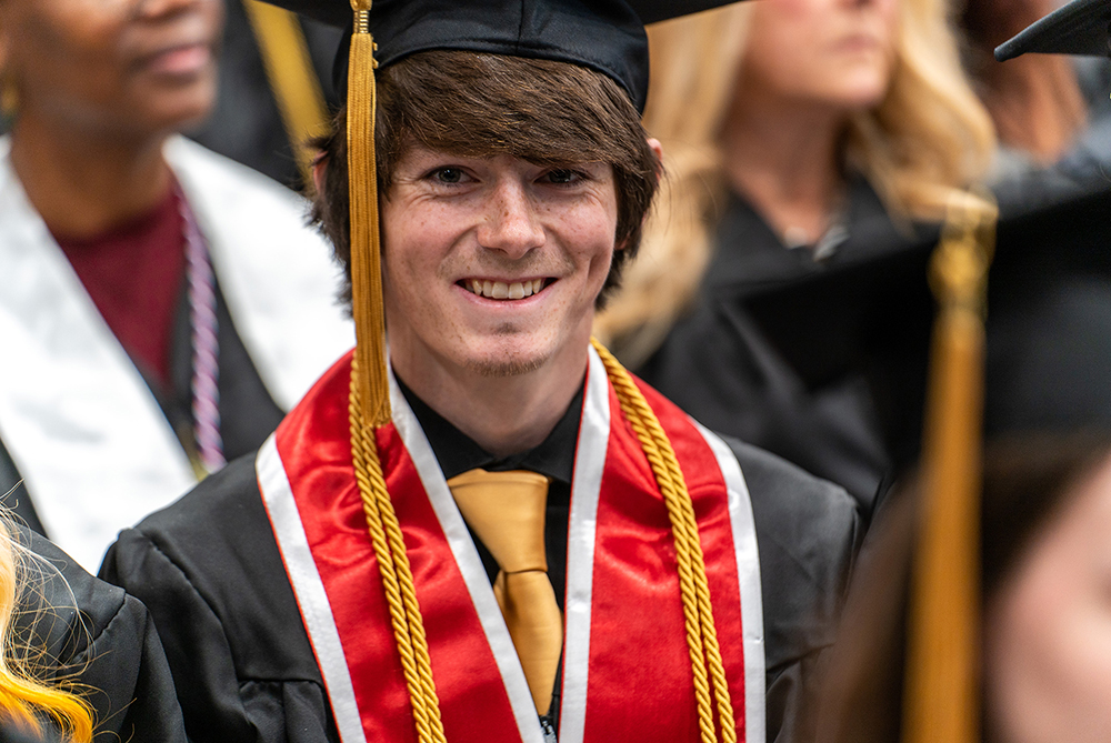 male graduate at UNCP commencement in regalia