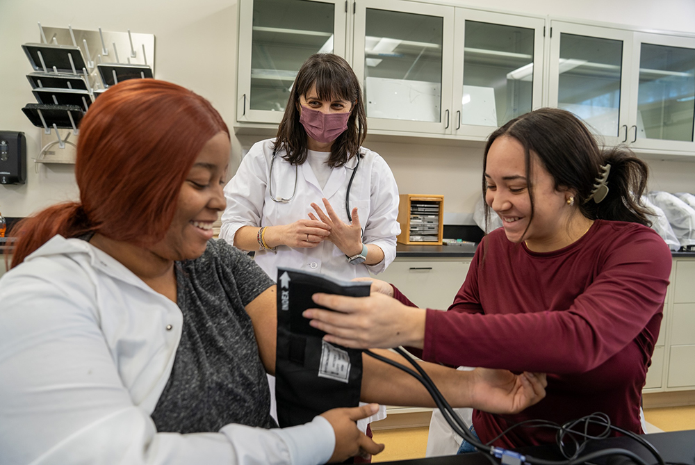Biology Blood Pressure Lab Silvia Smith with two female students smiling