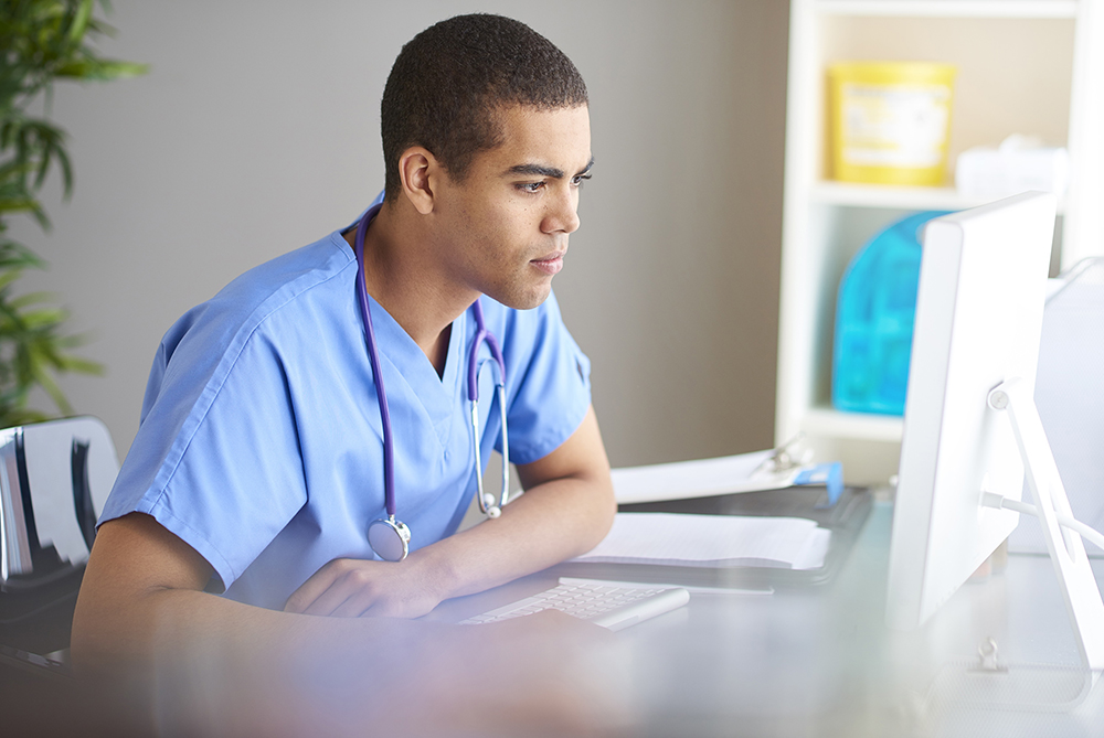 male nurse on laptop