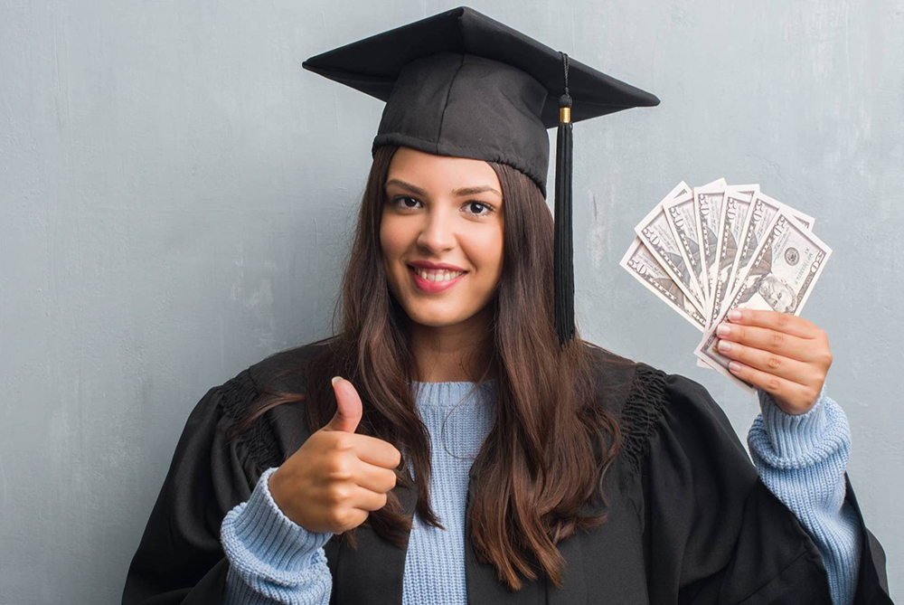 Graduate female holding money
