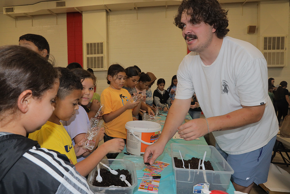 UNCP Service-Learning student working with elementary school students
