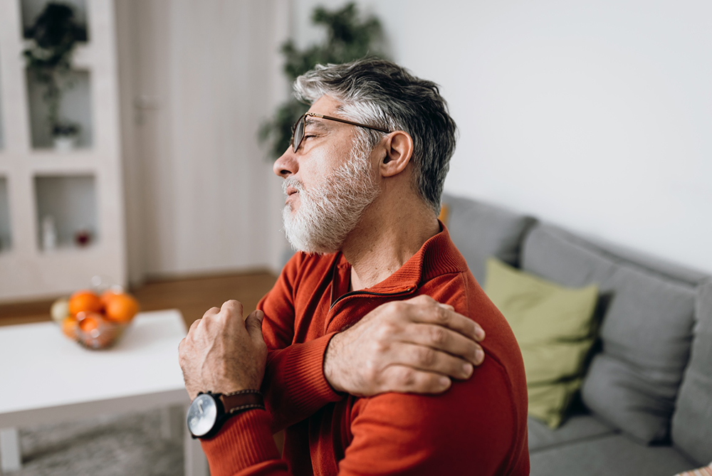 man holding his shoulder