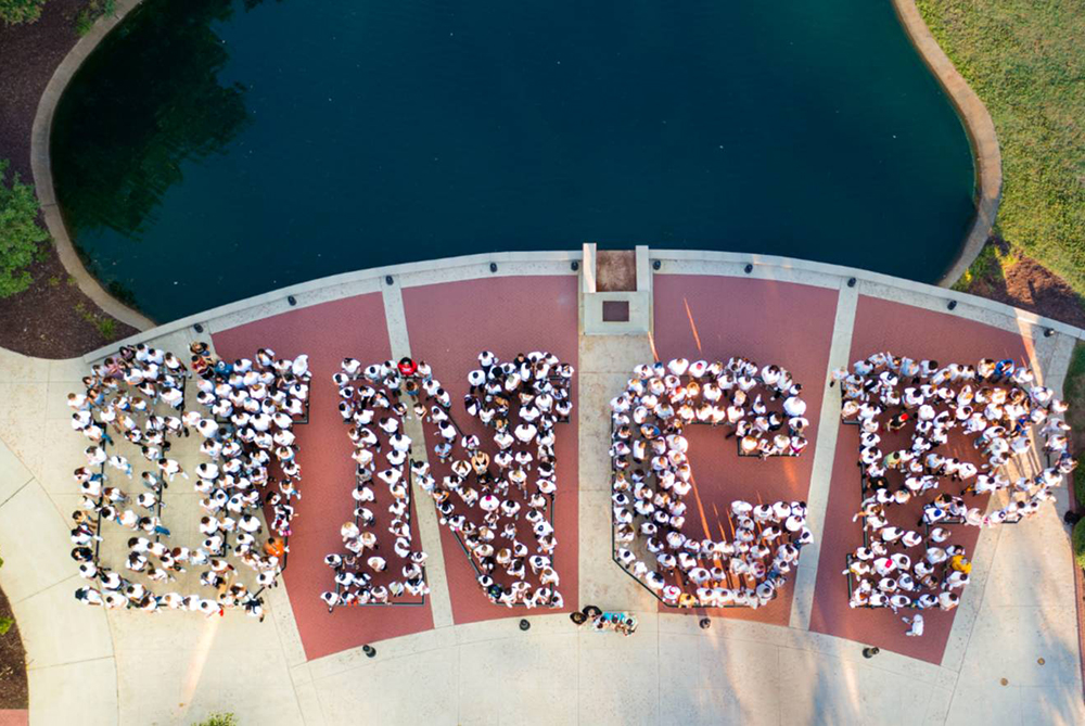 students form "UNCP" for drone shot on campus