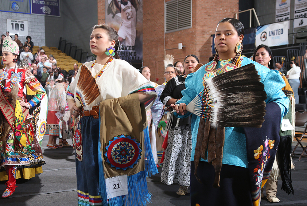 women standing at attention in their native dress