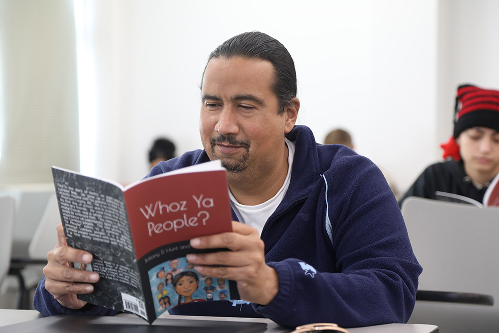 Native American student reads a book